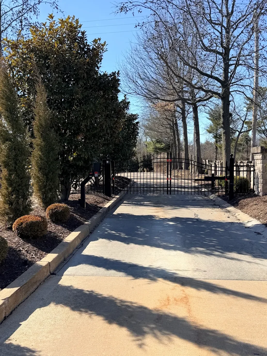 Secure gated community entrance with automated gate and intercom access system at private residential property in St. Louis Missouri.