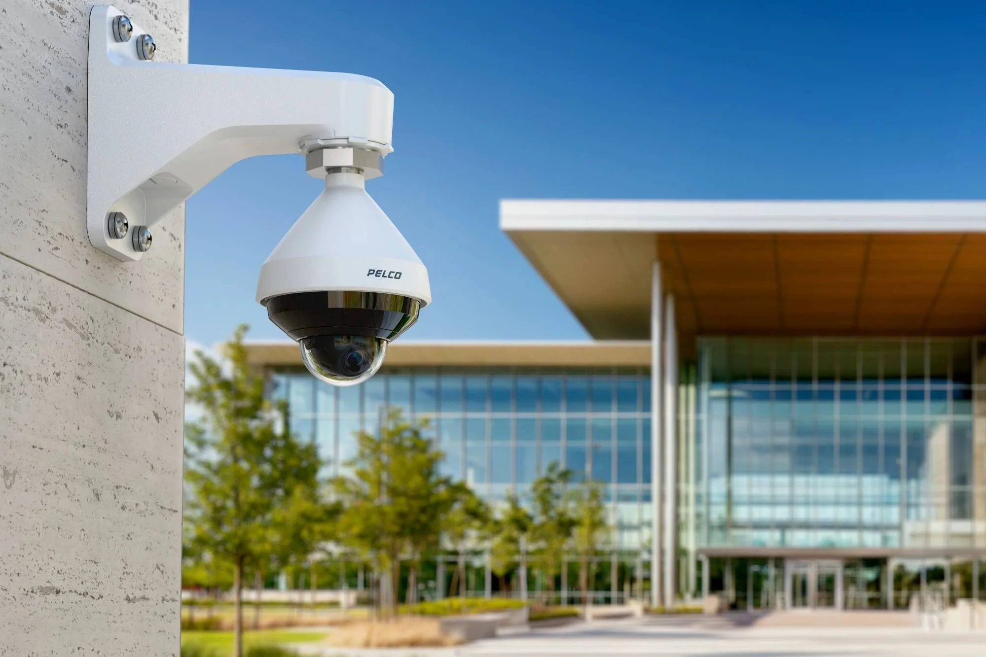 Pelco outdoor dome security camera installed on a building exterior, representing upgraded surveillance systems for commercial property protection and monitoring.