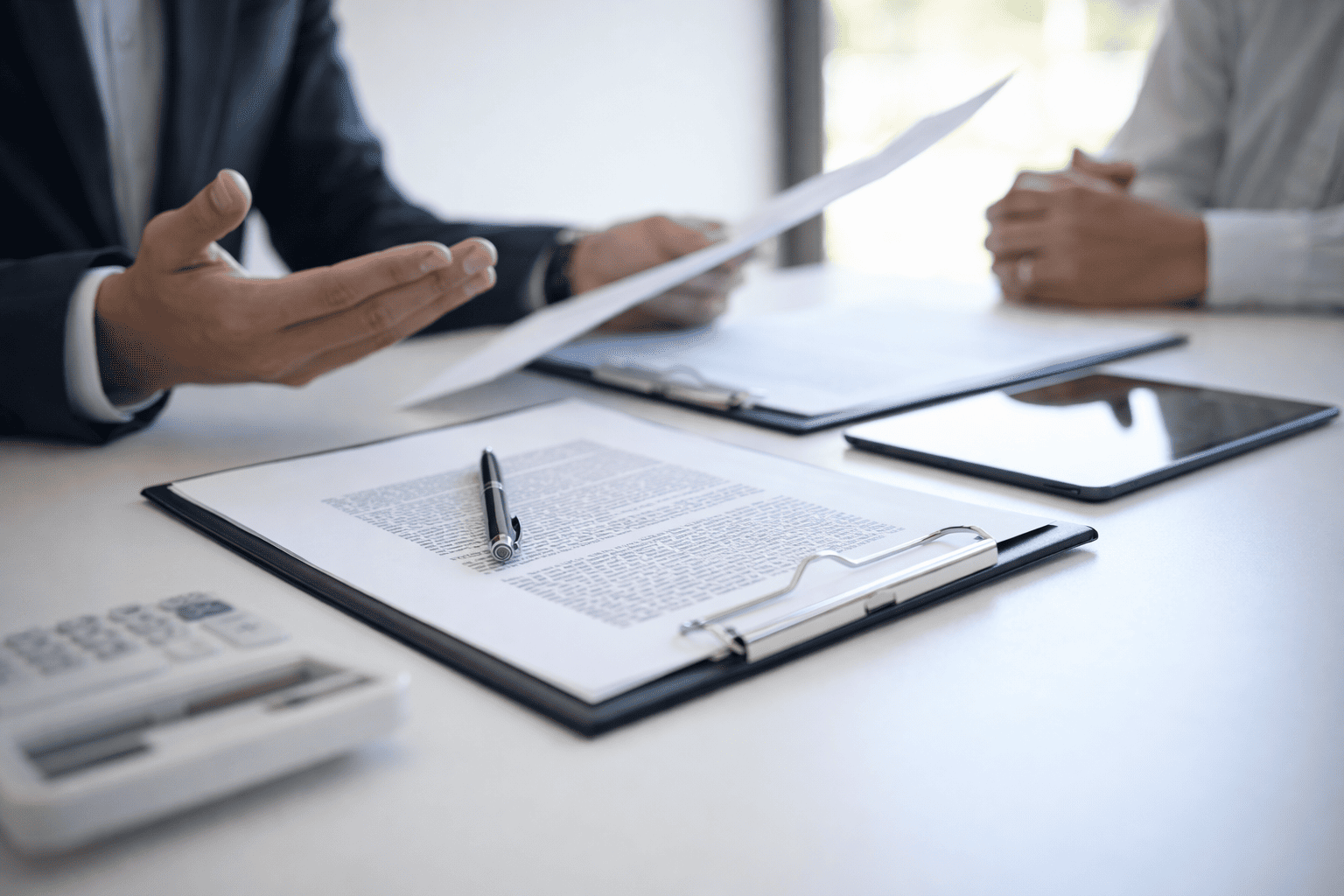 Security consultant reviewing commercial security documentation during independent evaluation meeting
