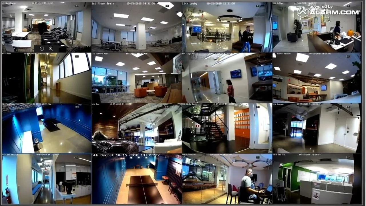 Alarm.com security camera monitoring dashboard displaying multiple live video feeds from a commercial building.