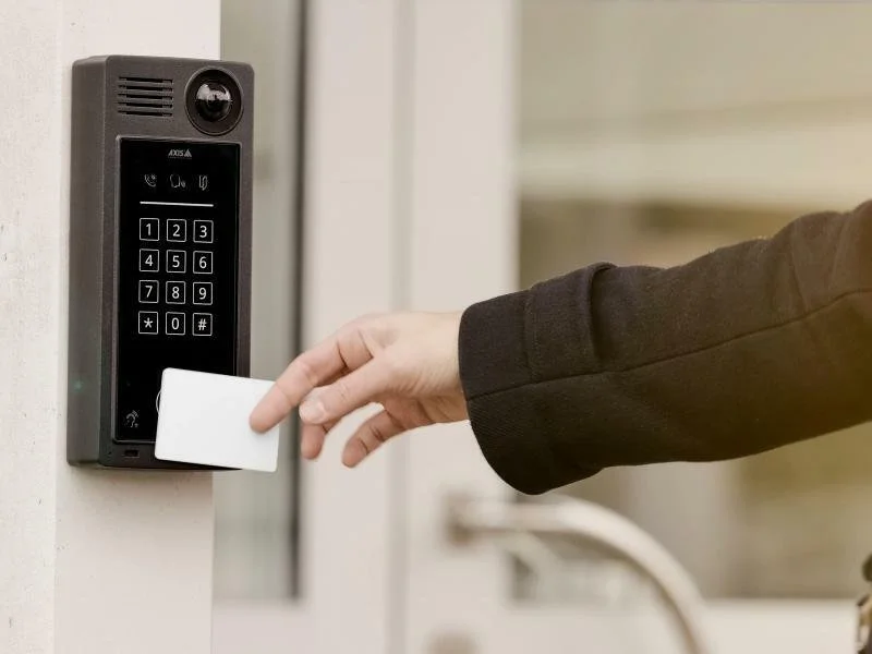 Axis access control card reader used for secure commercial building entry, allowing authorized users to unlock doors with an RFID access card.