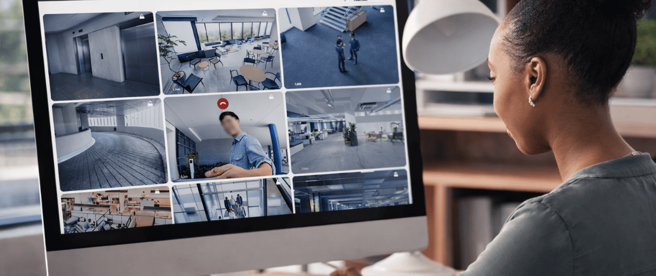 A Manhattan office security operator monitoring live CCTV feeds in a modern New York City commercial building