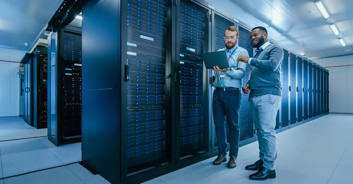 Technicians monitoring server racks in a data center, representing advanced security systems for technology and critical infrastructure facilities.