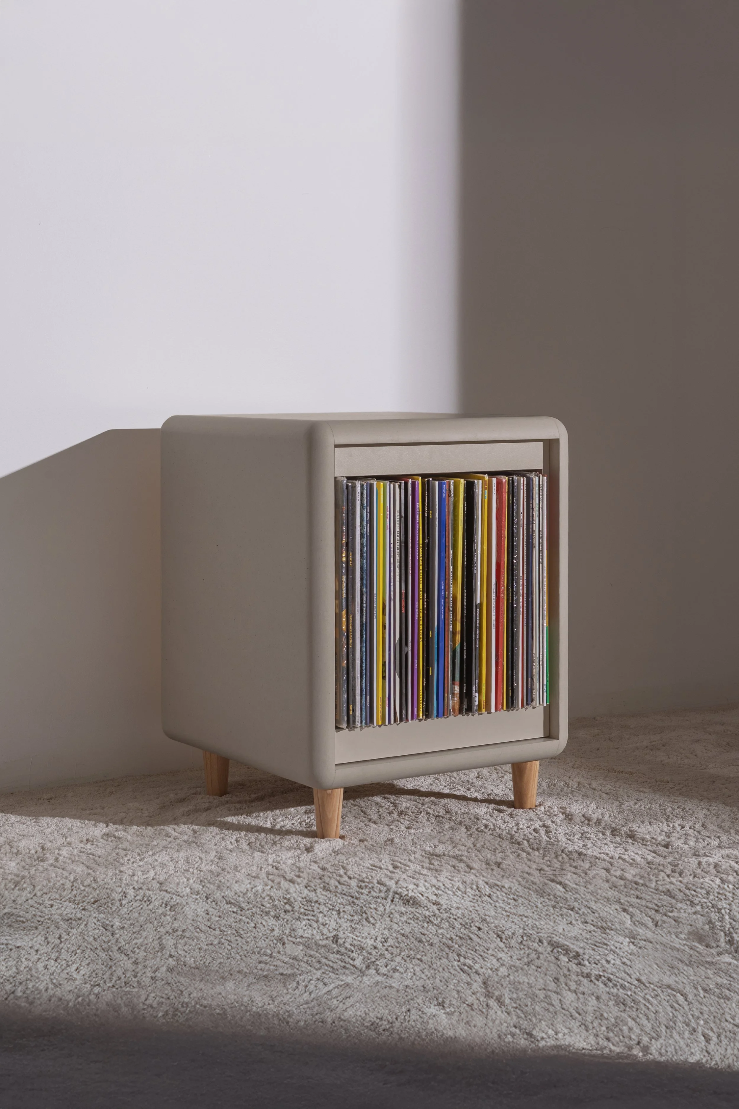 Otis Signature Piece by Groovaly in Light Grey finish, 3/4 view, filled with records, with Bloom element closed.