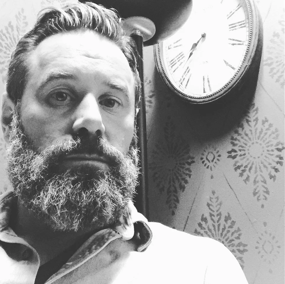 Robert Ryan Middleton, shop owner of Millheads Barbershop, inside the Pioneer Square location in Seattle, WA.