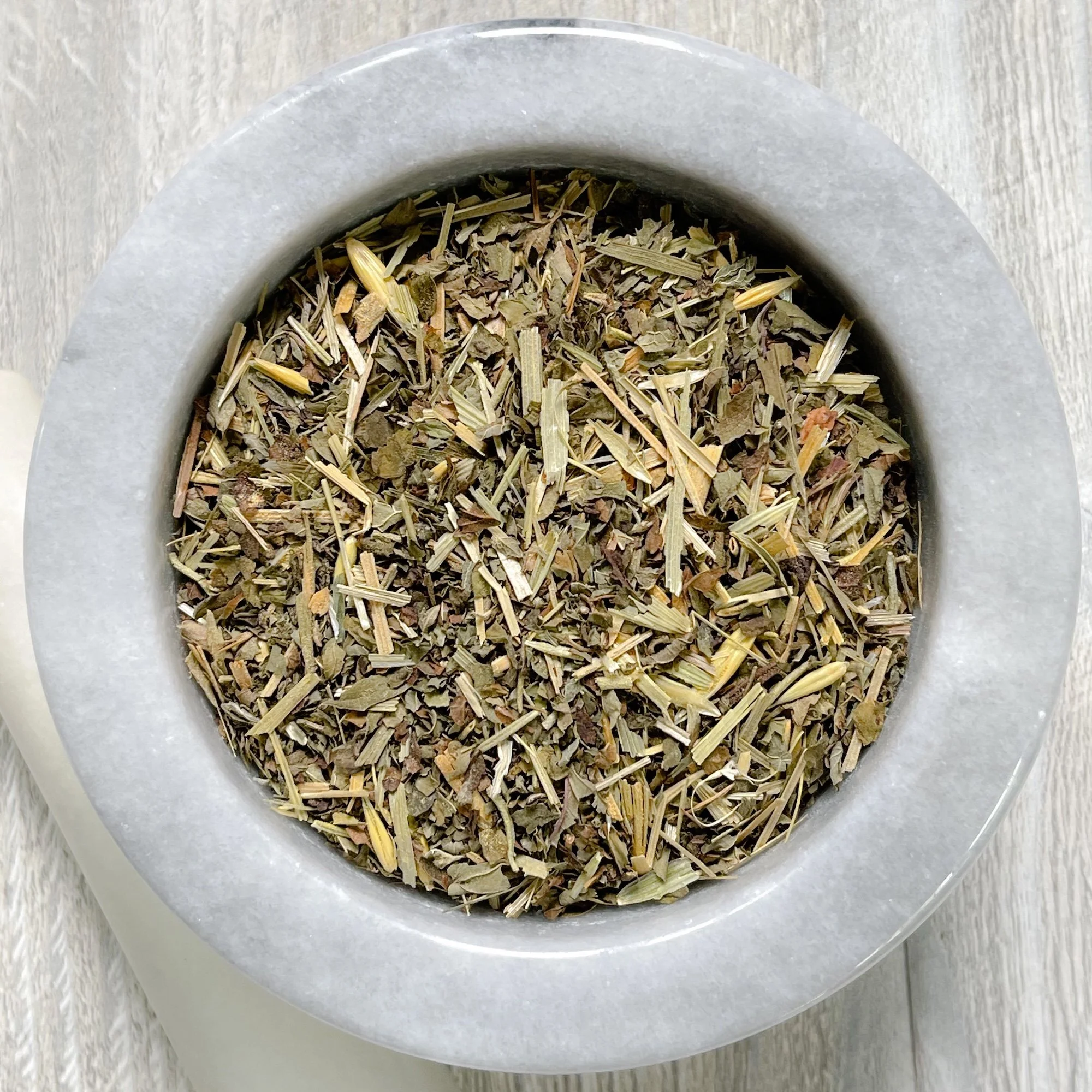 calm-and-clarity-tea.JPEG: loose tea in a marble mortar on a counter