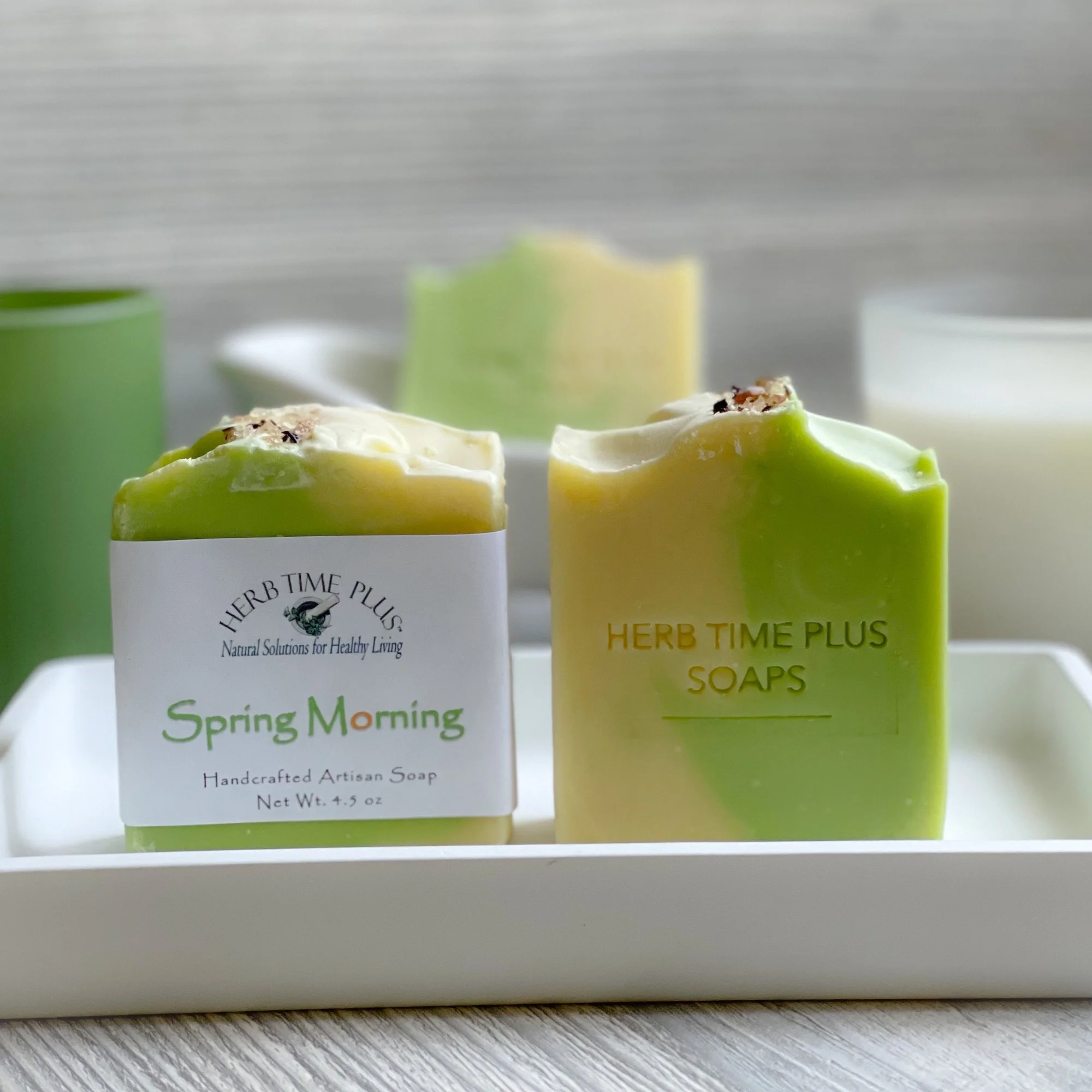 spring-morning-soap-display.jpeg: two bars of spring morning soap one with label and one without on a tray