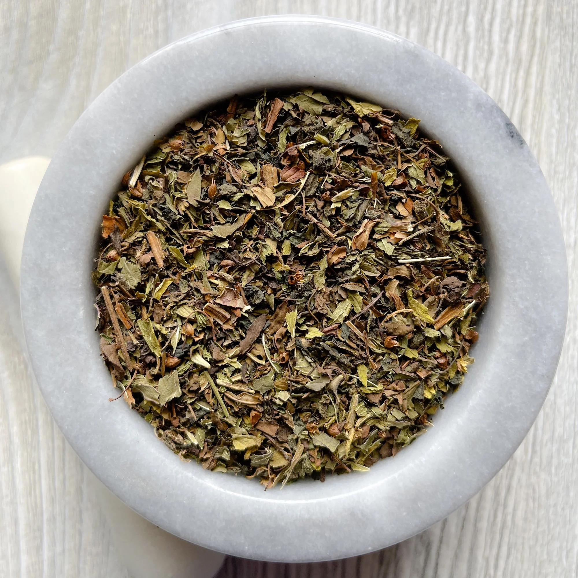 rejuvenating-tonic-tea.JPEG:loose tea in a marble mortar on a counter