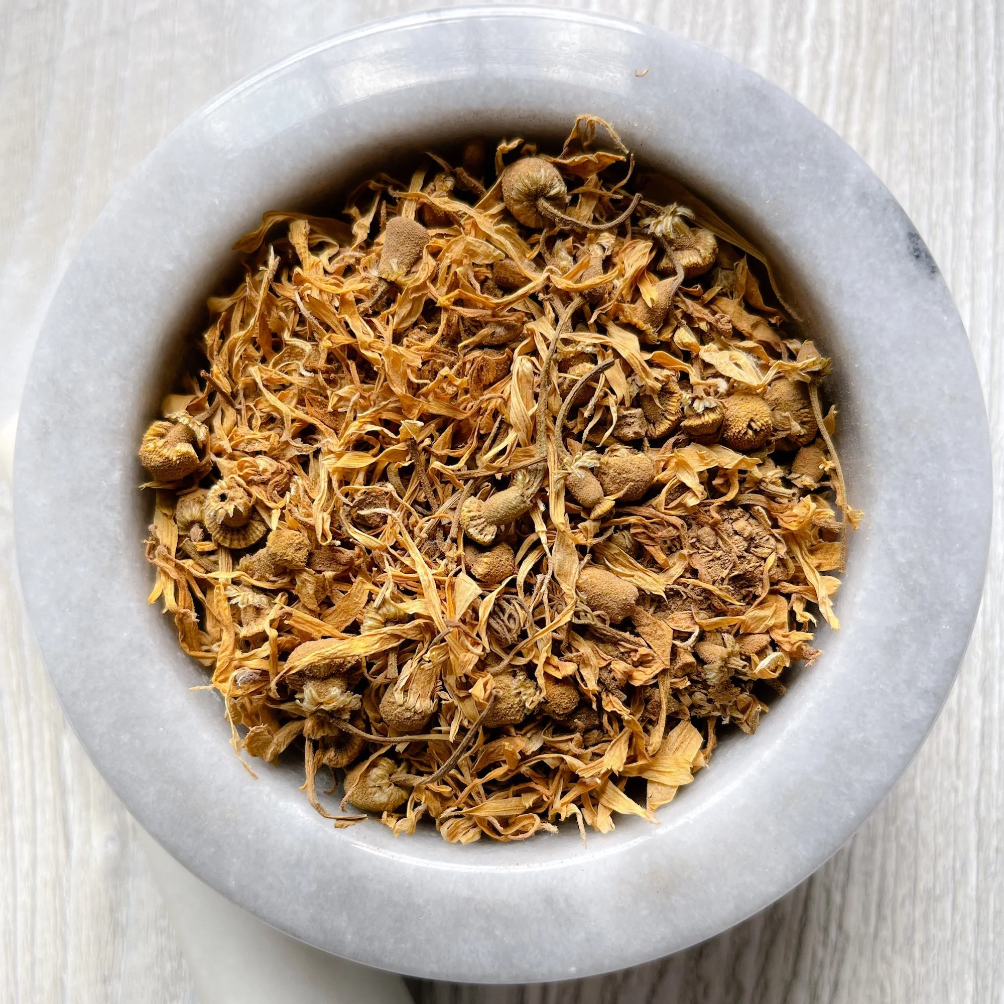 skin-glow-loose-tea.JPEG:loose tea in a marble mortar on a counter