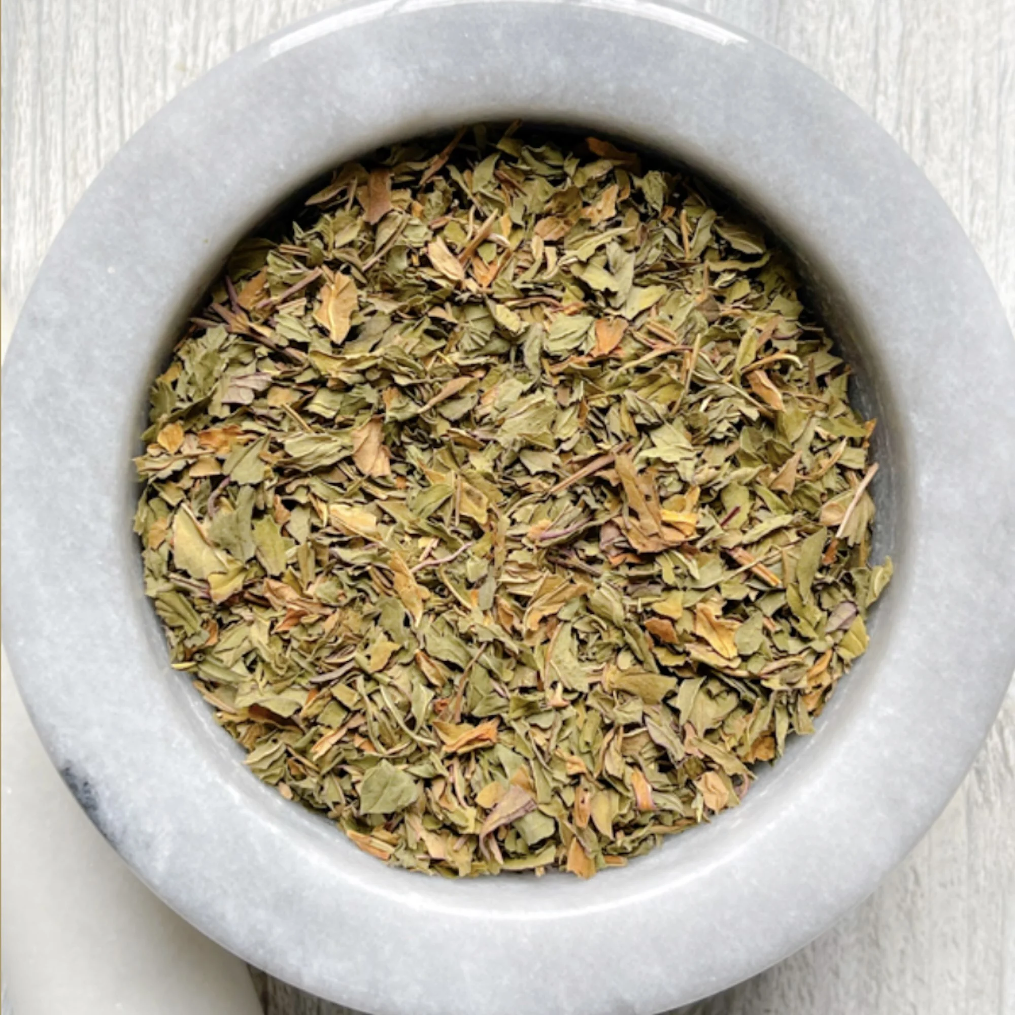 peppermint-leaf.jpg: loose peppermint leaf tea in a mortar