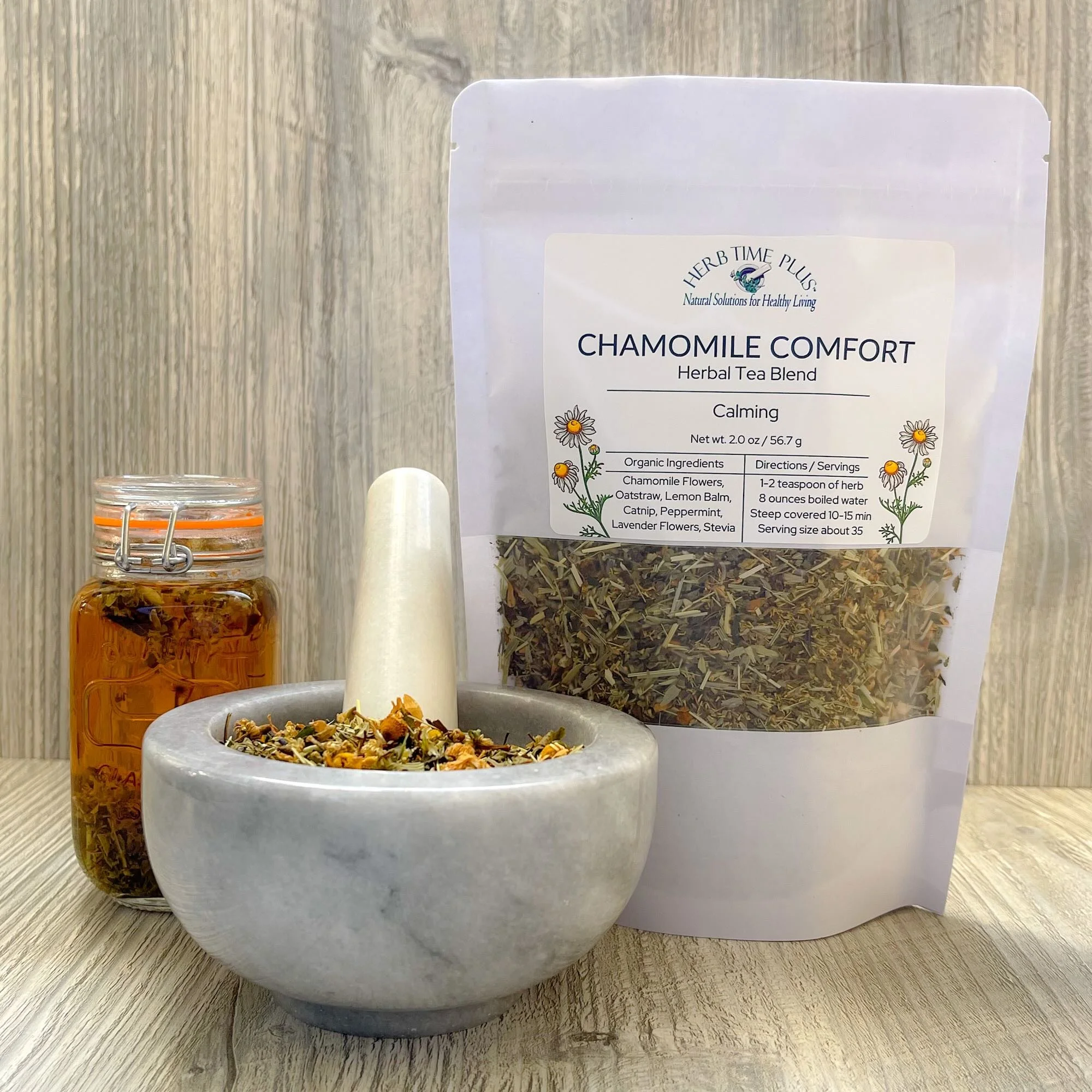 chamomile-herbal-tea-blend-product-display.jpeg: chamomile comfort herbal tea blend with bag, loose herbs, and brewed tea