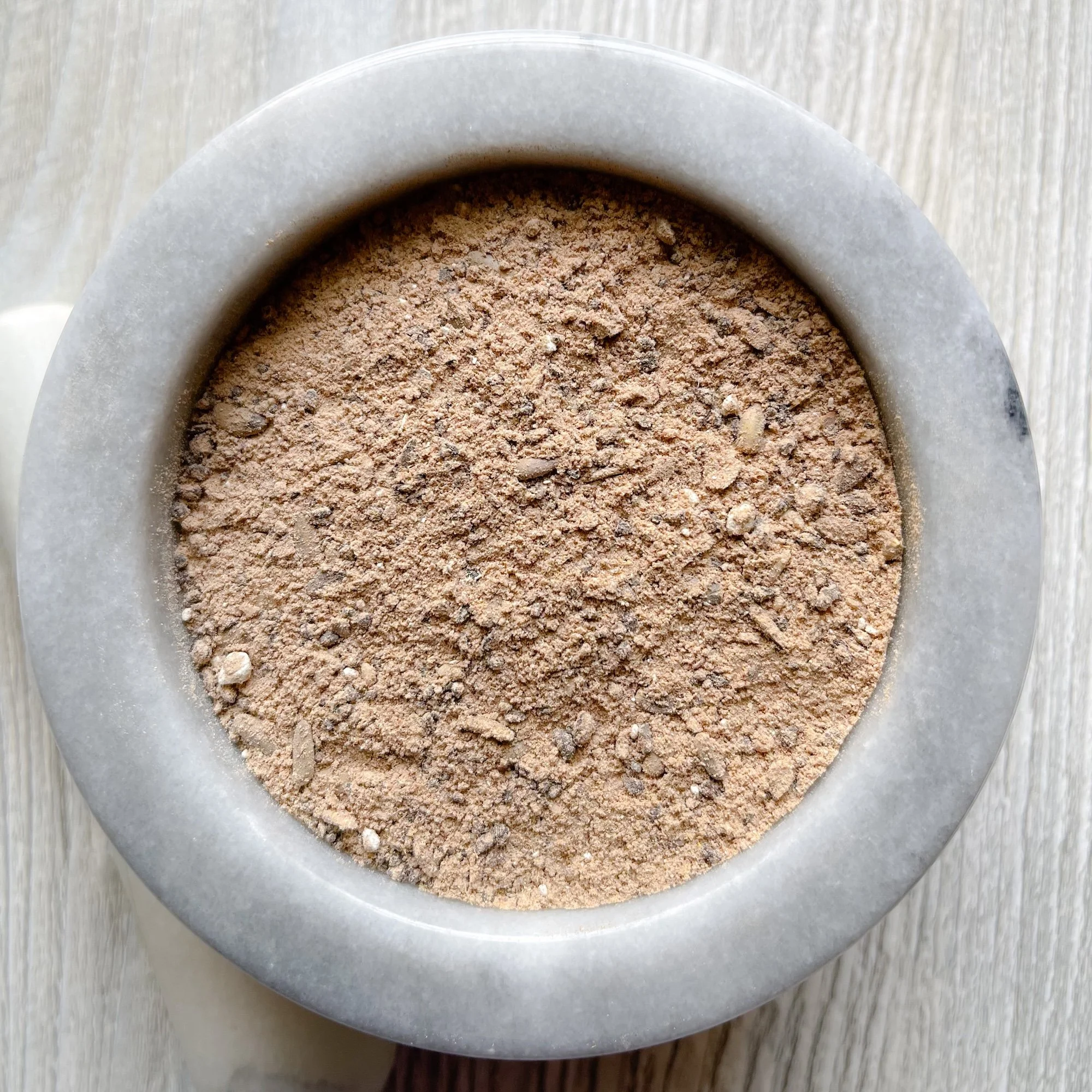 liver-support-tea.JPEG:loose tea in a marble mortar on a counter