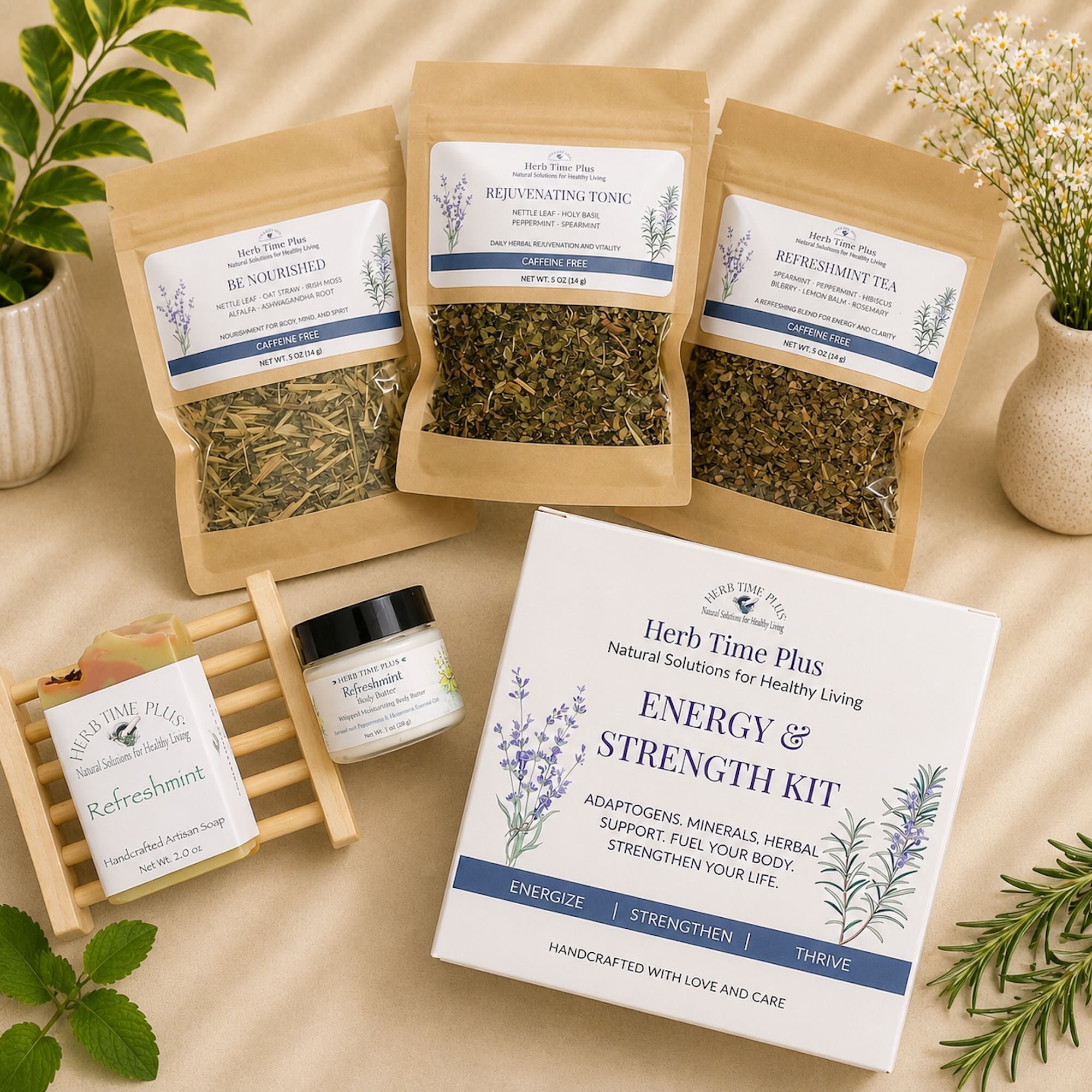 energy-and-strength-wellness-kit-herb-time-plus.jpg: three loose leaf bags of tea, bar of soap, bottle of body butter on counter surrounded by herbs