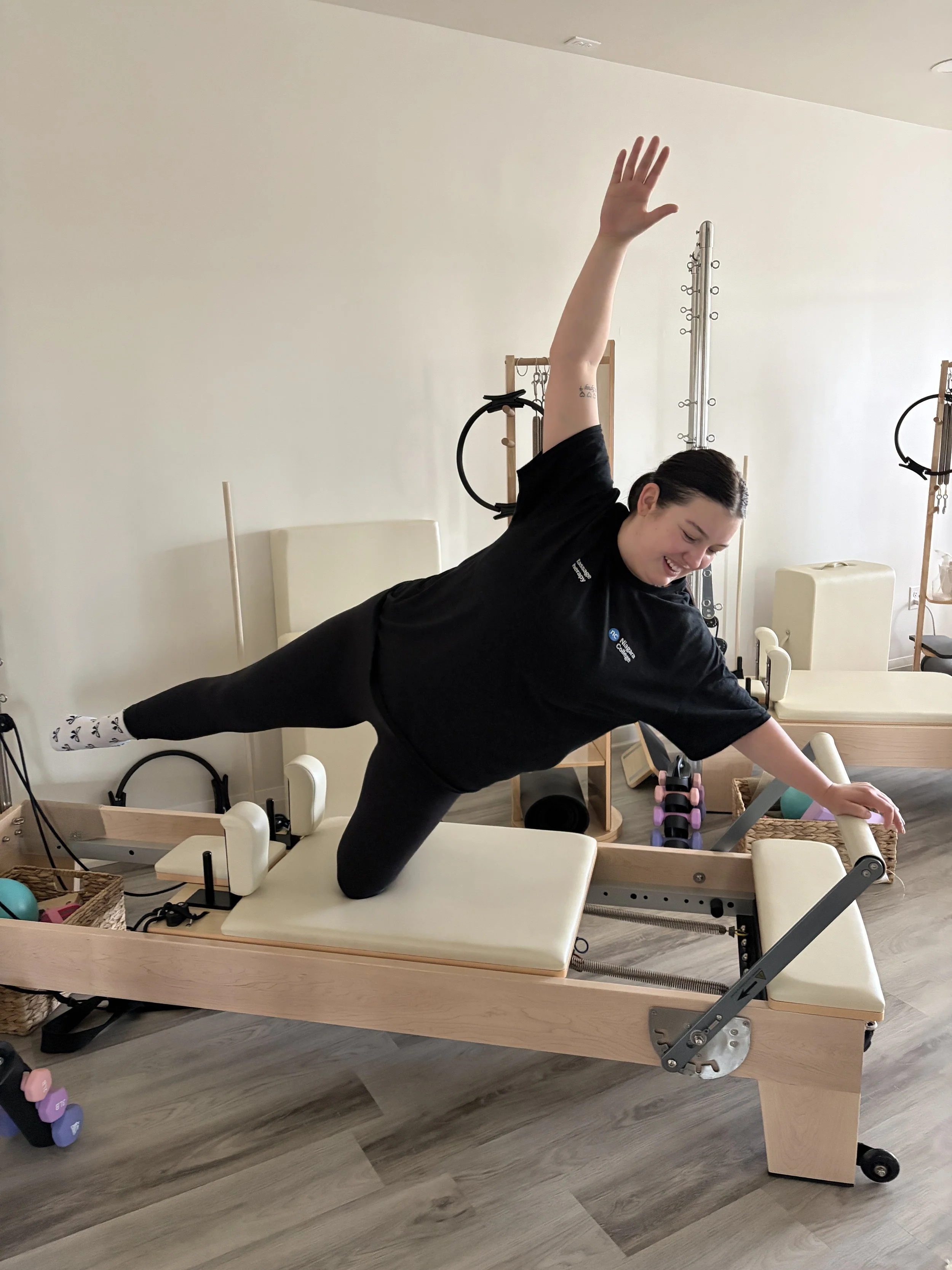girl doing side plank on Pilates reformer