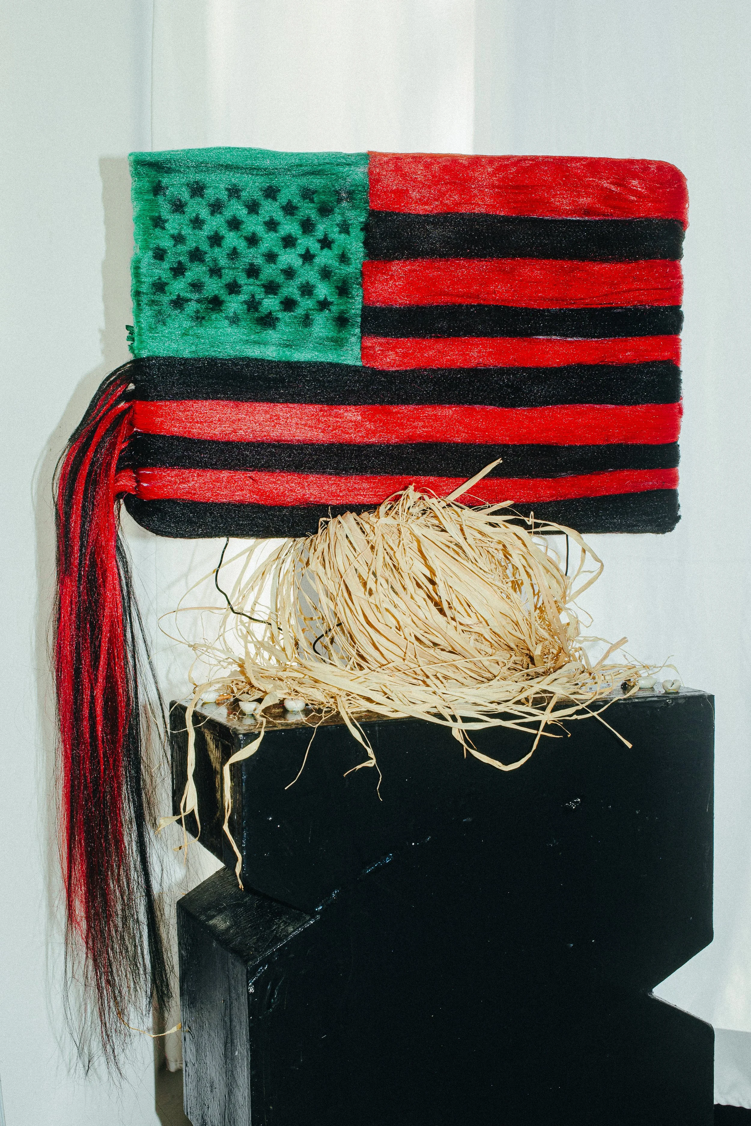   Asia Mason’s  Black American flag woven out of kanekalon braiding hair&nbsp; 