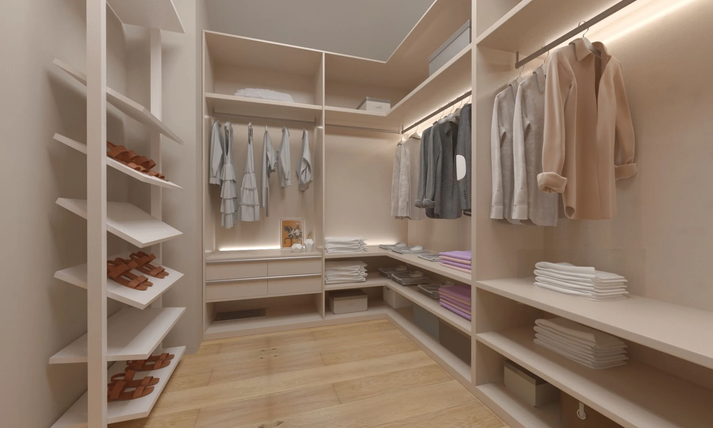 Walk-in closet with beige walls, wooden flooring, and organized clothing on shelves and racks, including shirts, blazers, and folded towels.