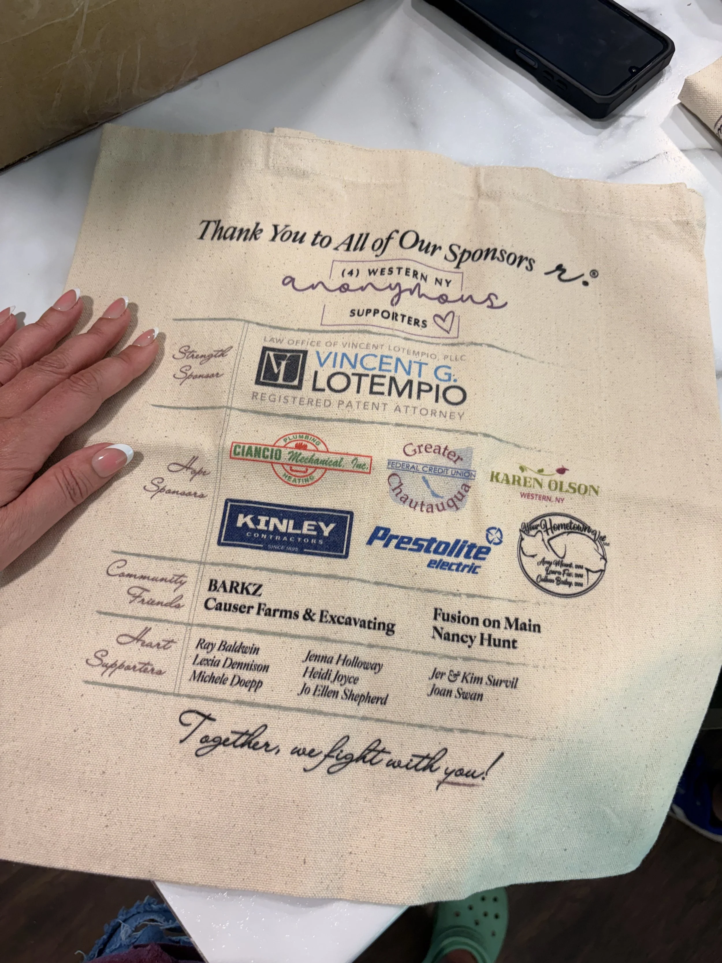 Sponsorship tote with sponsor logos displayed.