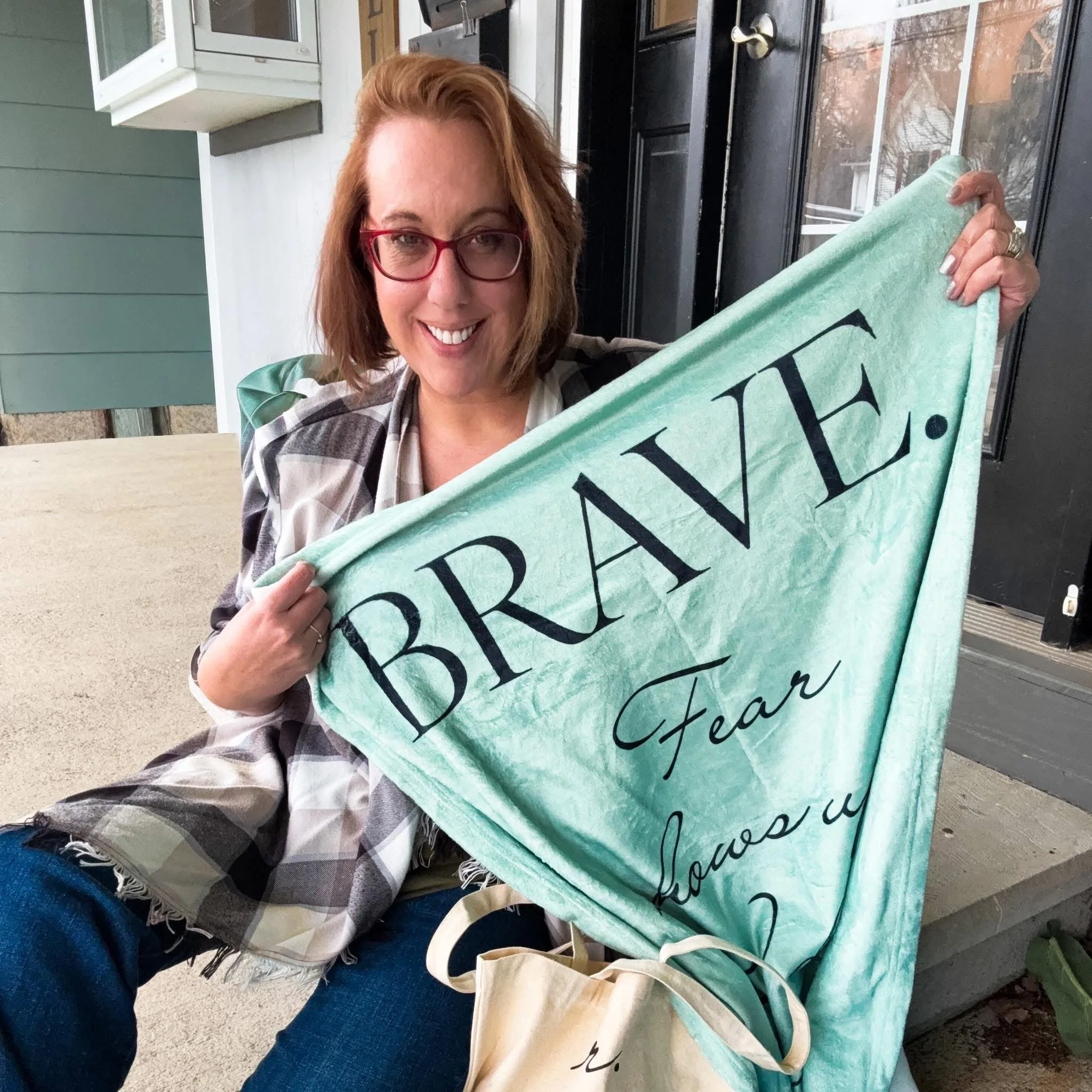 Kim Survil holding up the sample of the BRAVE blanket. Fear shows up. I do it anyway.