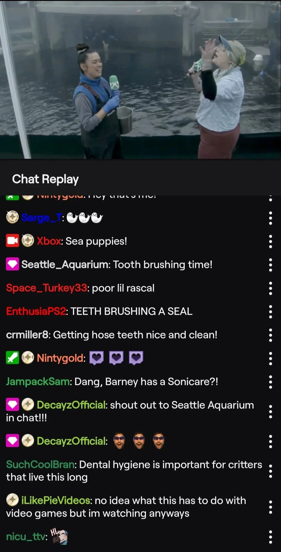 Xbox Twitch chat replay showing viewer reaction to a seal getting its teeth brushed, including the comment "Dang, Barney has a Sonicare?!" and "no idea what this has to do with video games but I'm watching anyways."