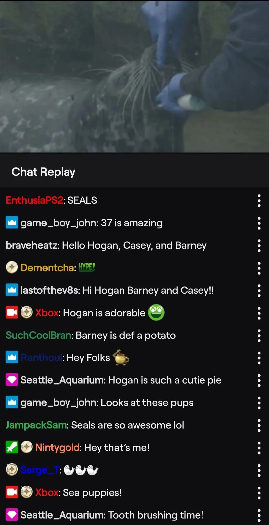 Xbox Twitch chat replay showing viewers naming the Seattle Aquarium seals Hogan, Casey, and Barney during the Xbox Earth Day stream, with Seattle Aquarium active in chat announcing tooth brushing time.