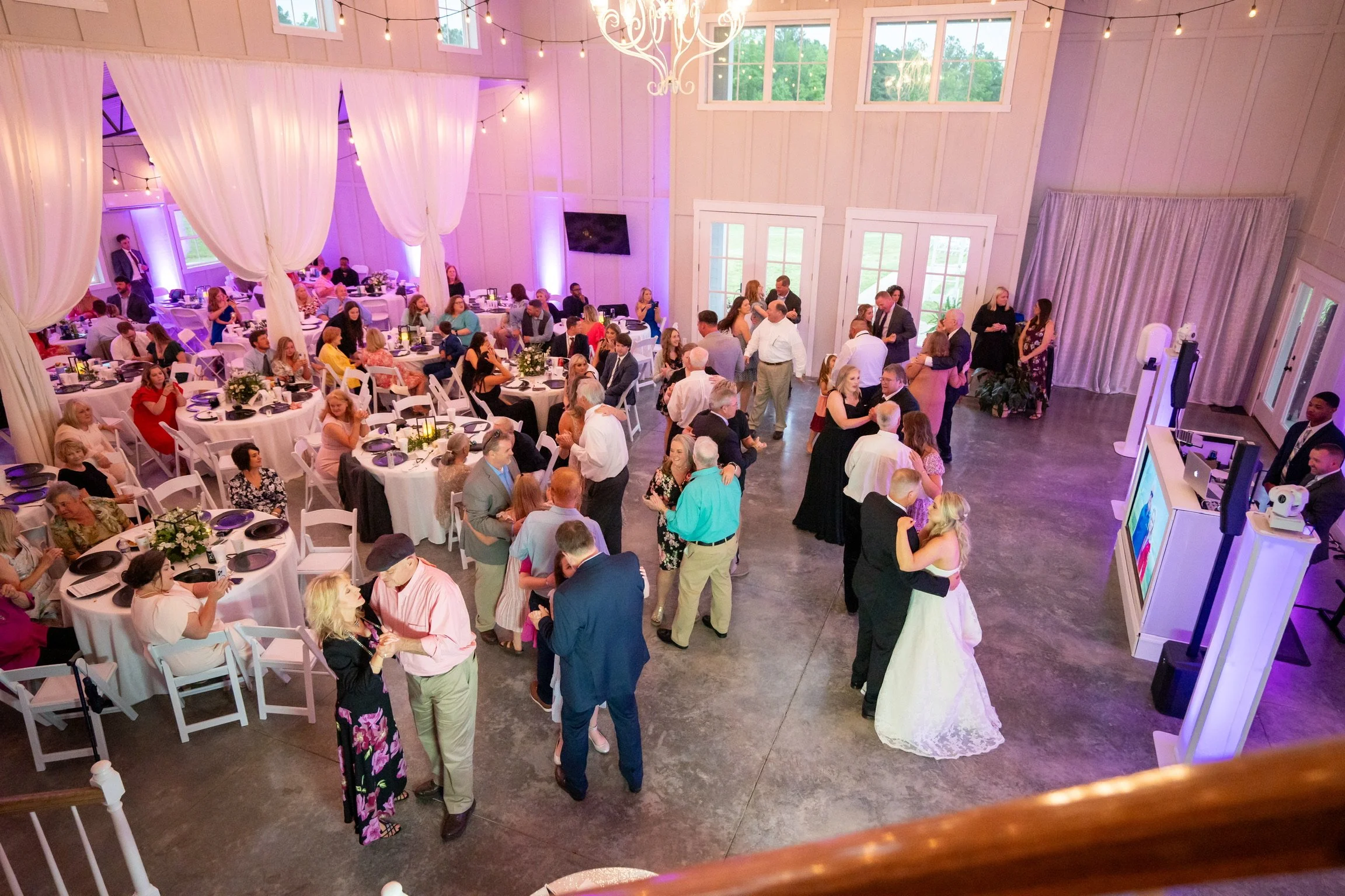 Large group of wedding attendees dancing to music played by a DJ from Epic DJ Entertainment.
