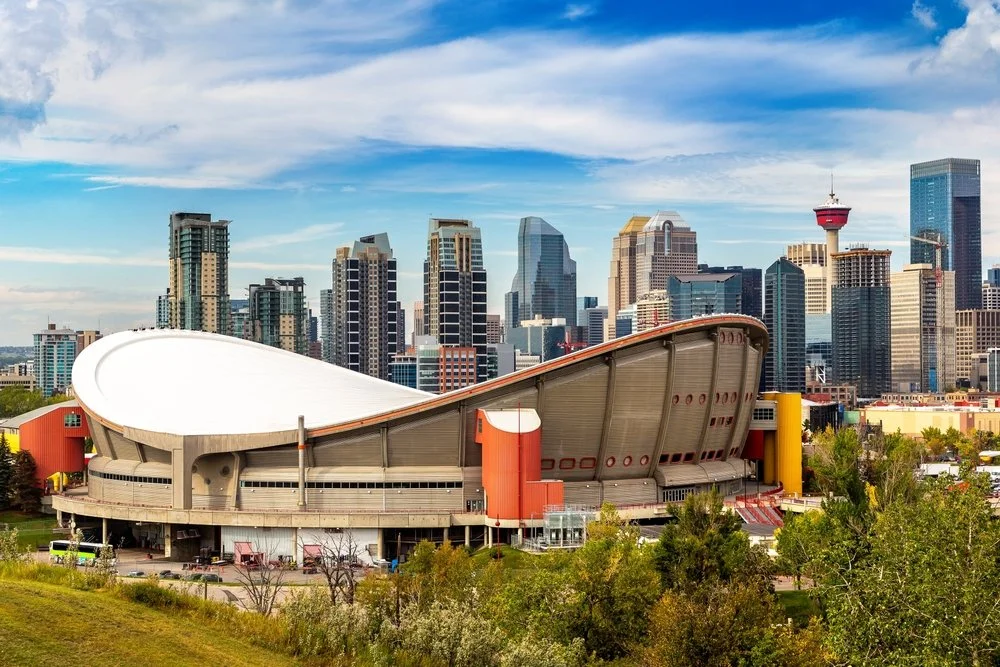Calgary skyline with the Scotiabank Saddledome in the foreground on a clear day.