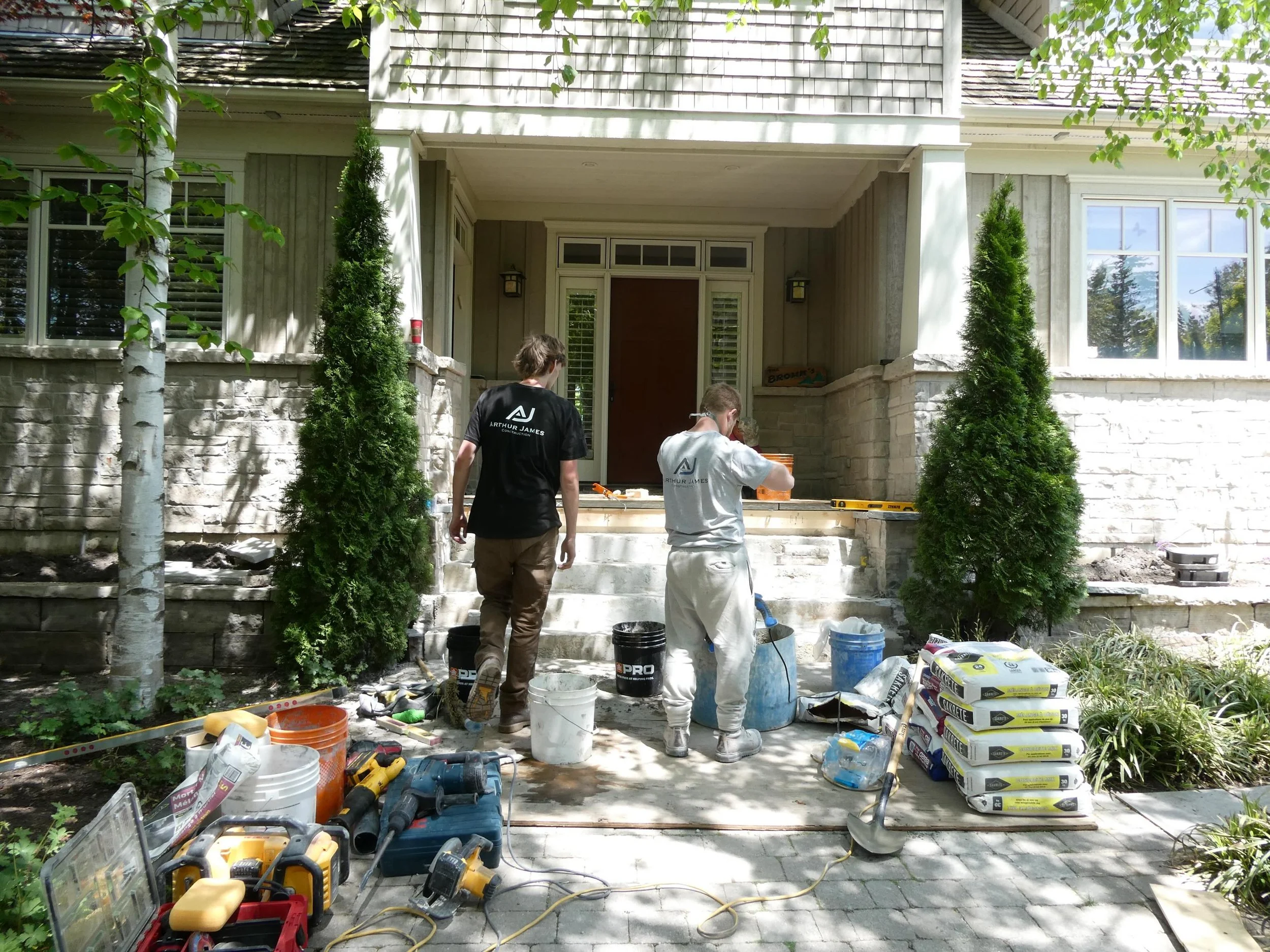 Not every photo is a finished project. Sometimes it&rsquo;s the crew mixing mortar, staging materials, and making sure everything is ready before the stone goes on. This project features Dove Grey Banas stone with a rock face finish, and we&rsquo;re 