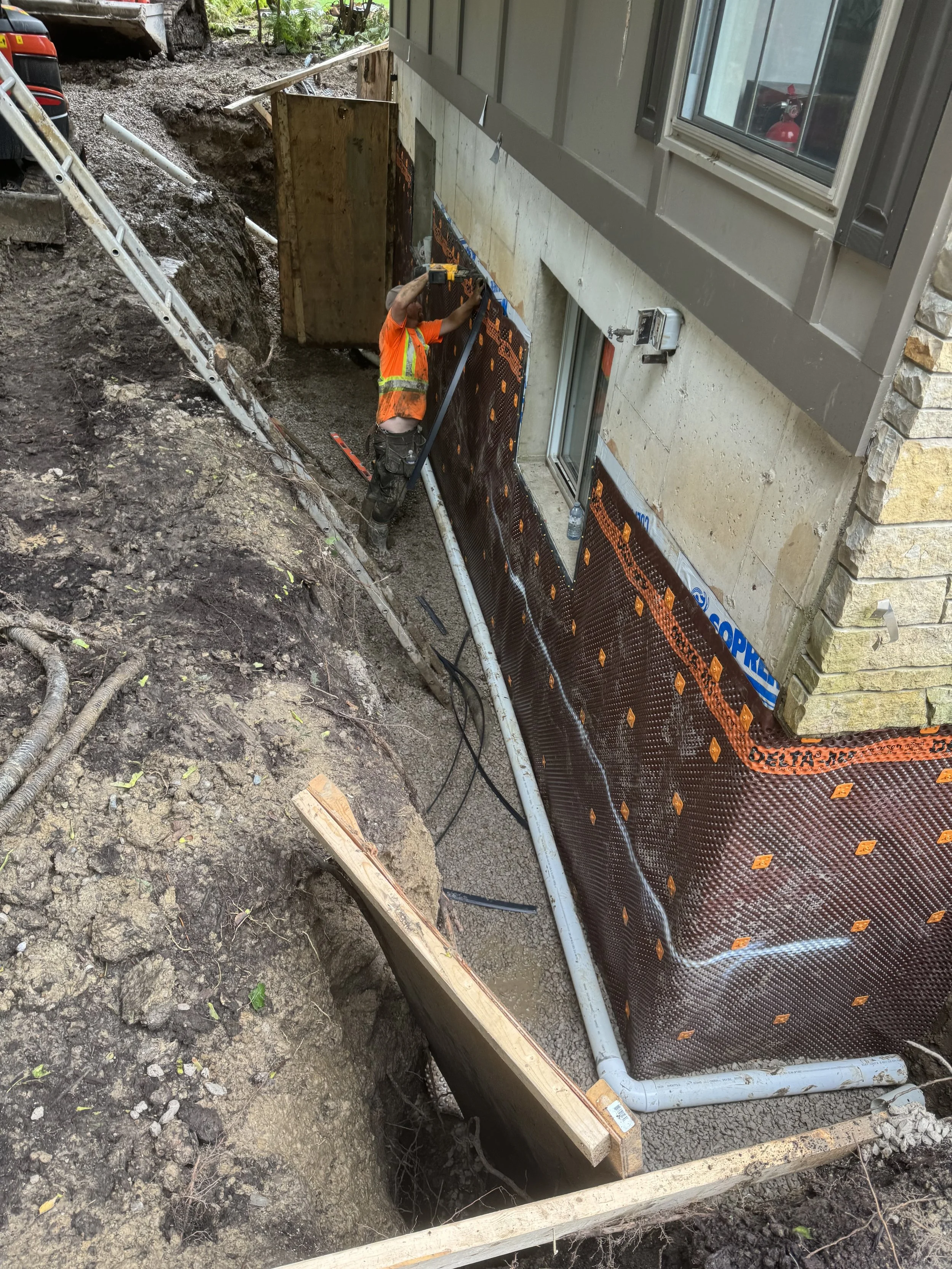 Waterproof membrane applied to residential foundation wall in Wasaga Beach
