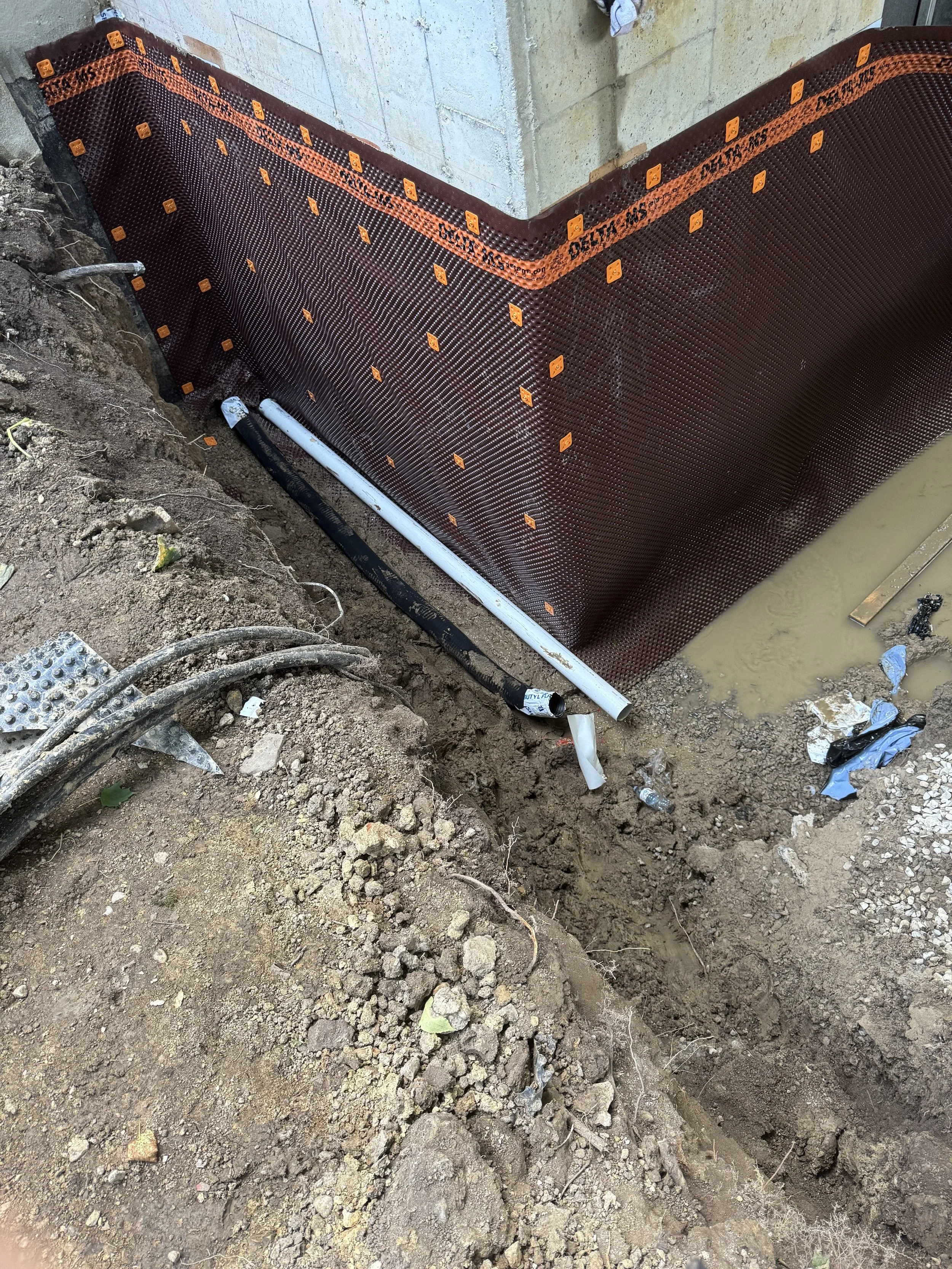 Foundation waterproofing and drainage system installation on residential home