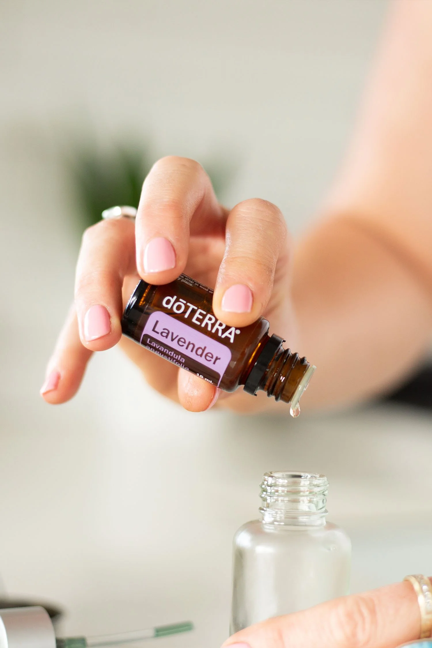 doterra-lavender-essential-oil-amber-bottle-in-hand