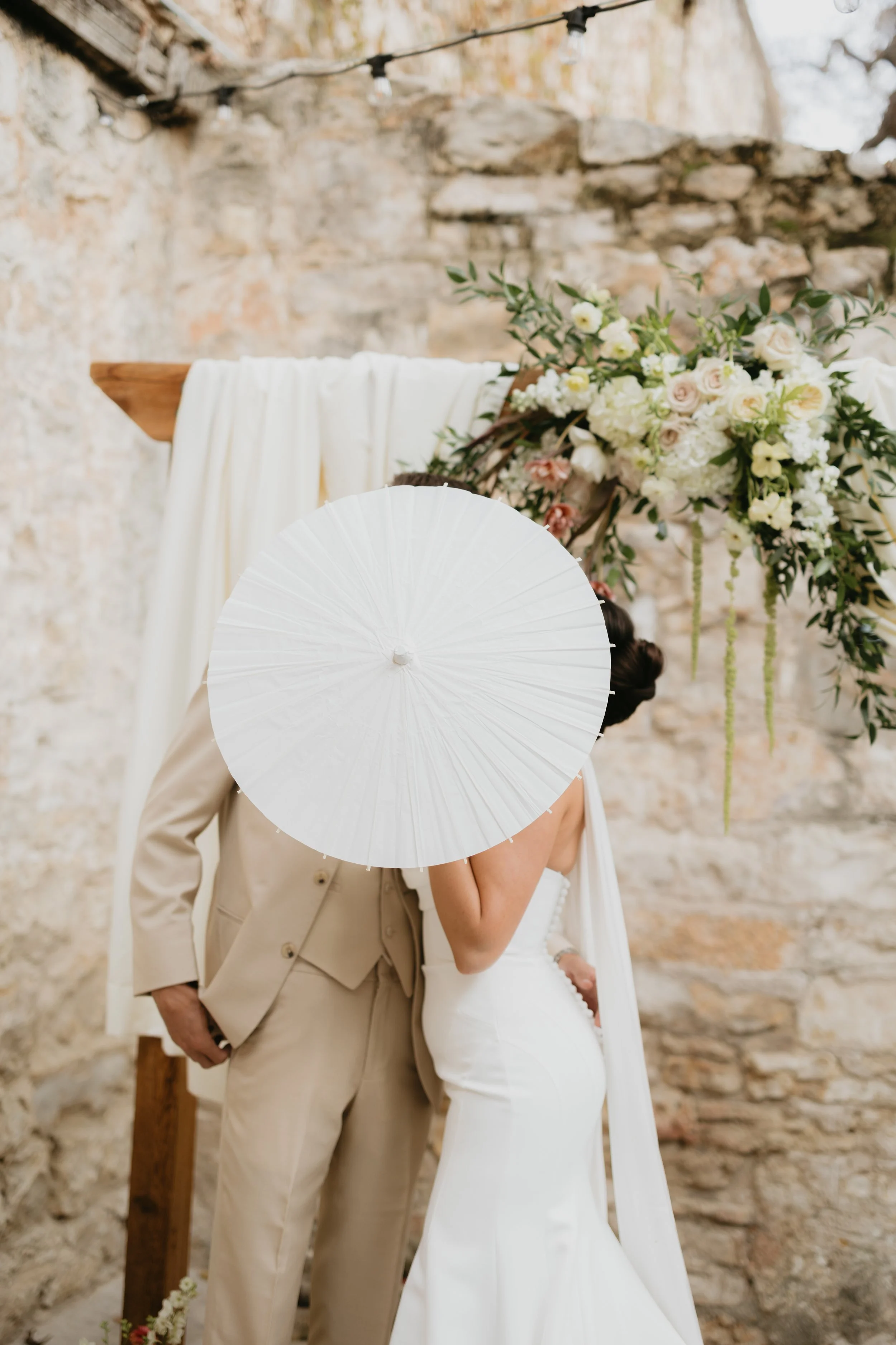 Bride and groom behind a parasol
