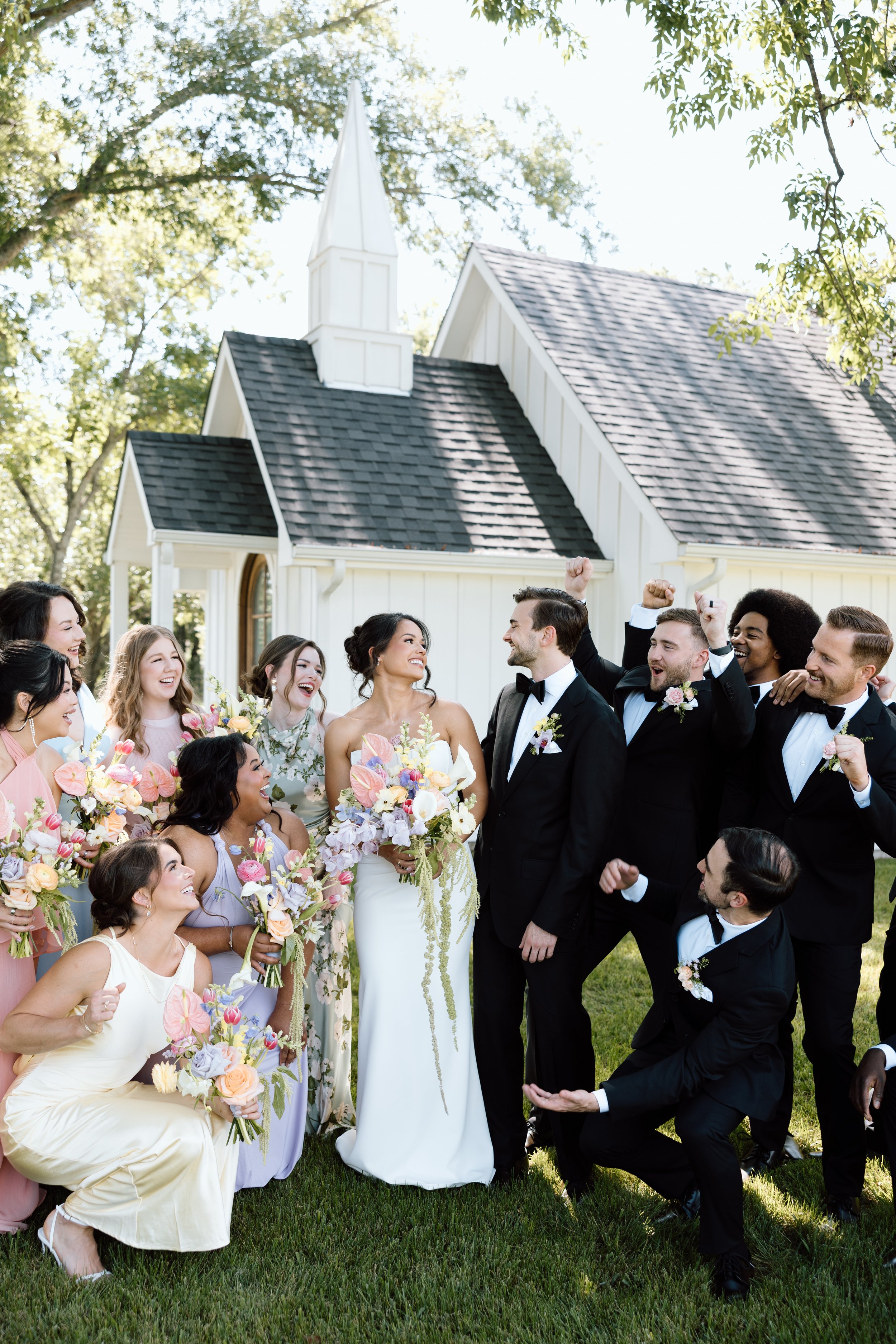 full wedding party in front of The Emerson Venue chapel