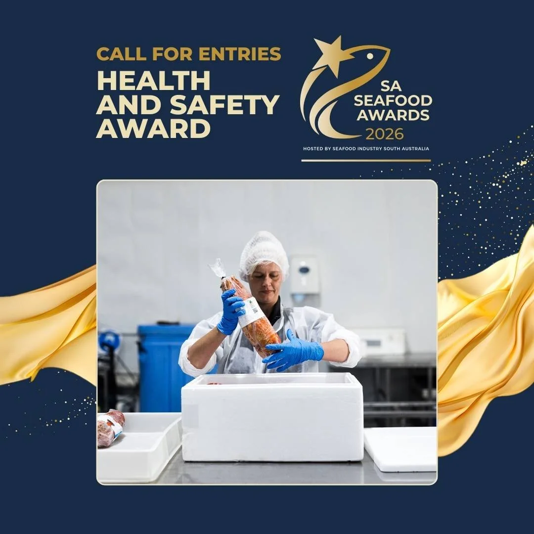 A person wearing a hairnet, white coat, and blue gloves is packaging seafood in a commercial kitchen setting for the SA Seafood Awards 2026.