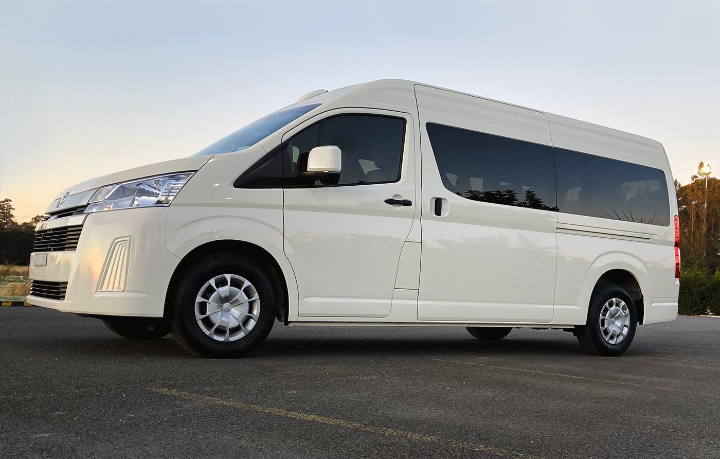 Altamira Transport's Toyota passenger van with a sunset background.  