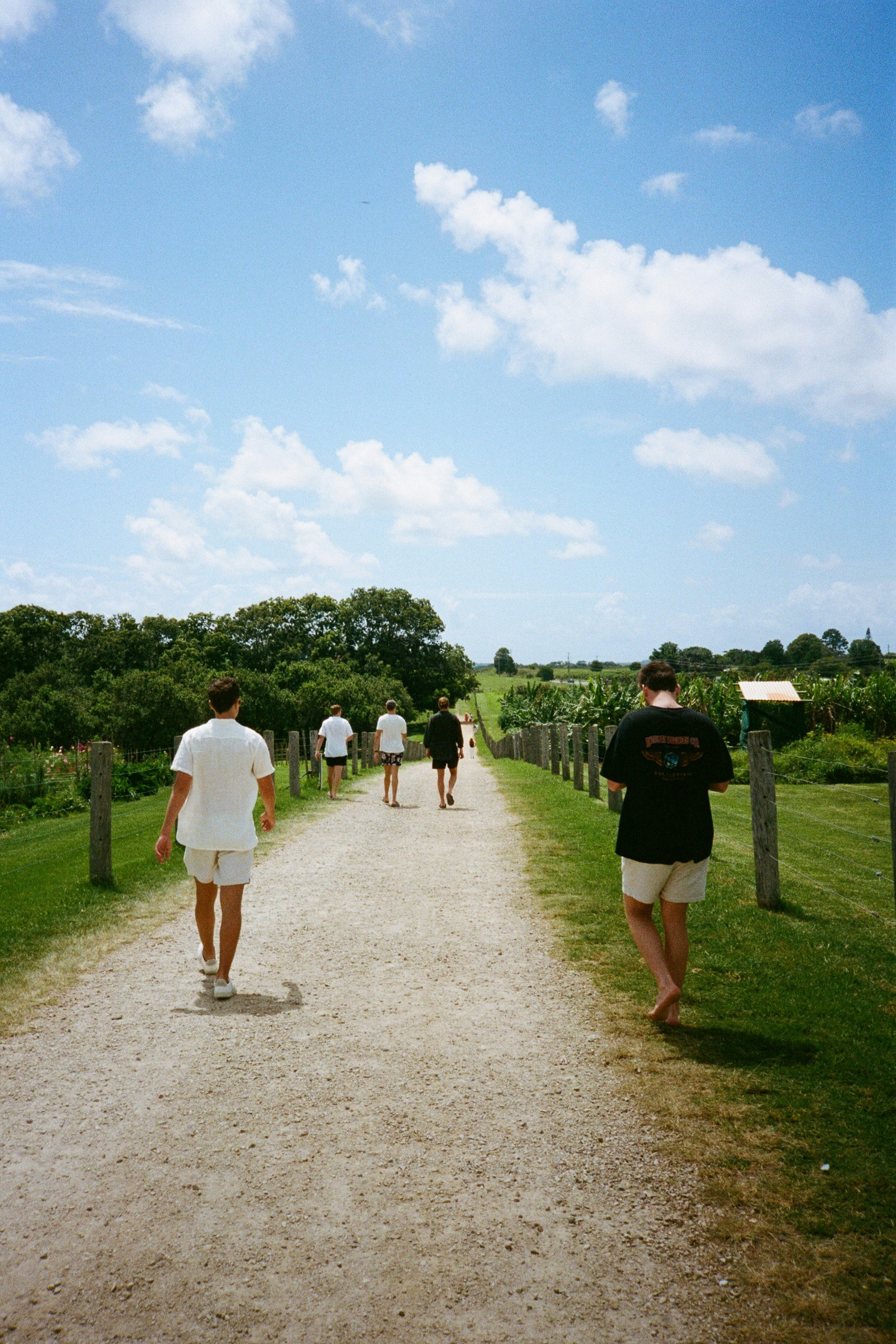 Altamira Transport clients walking through a dirt path during a wine tour in rural New South Wales.