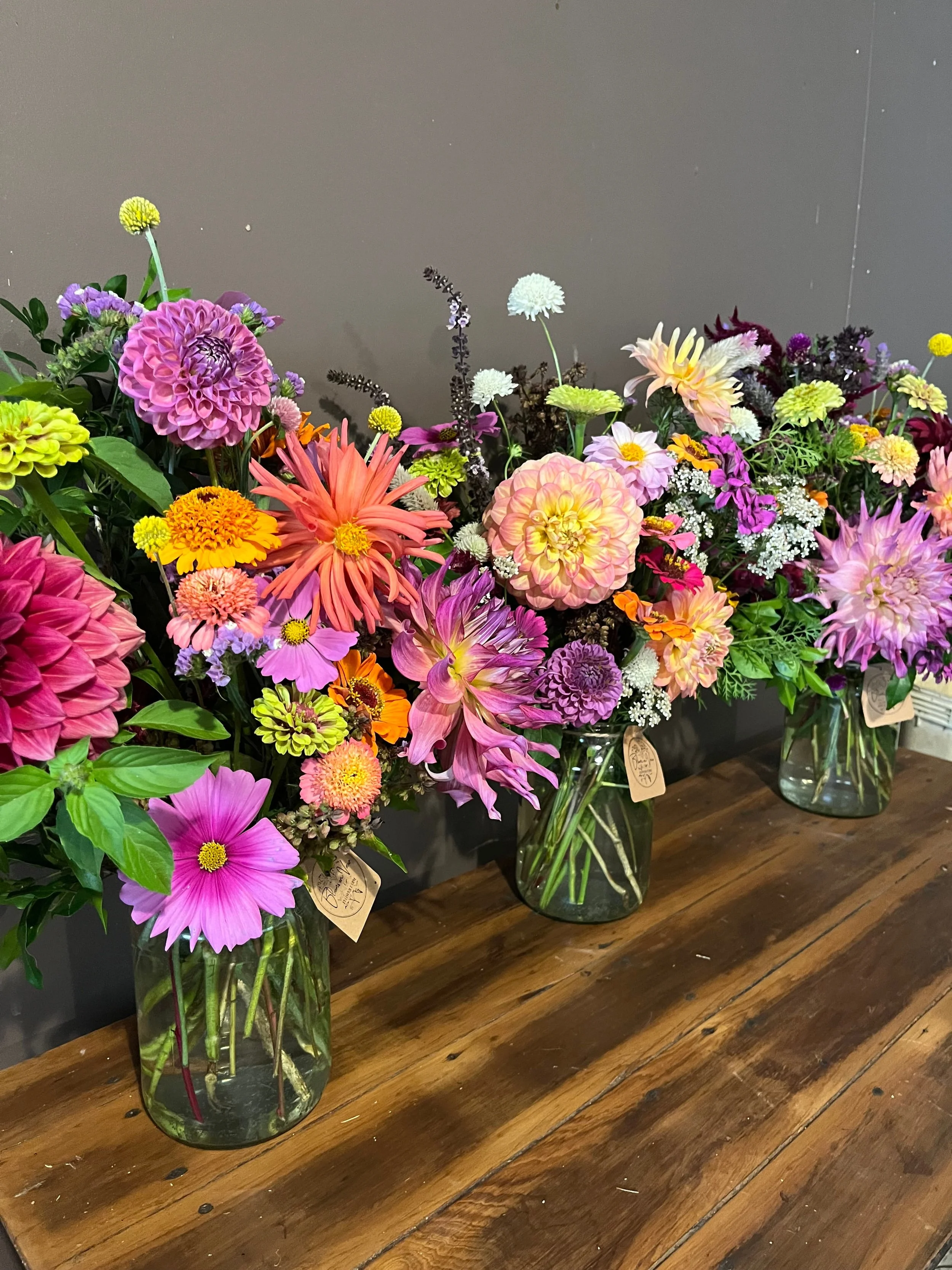 multiple-flower-arrangements-on-wooden-bench.jpg