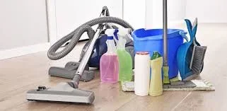 Cleaning supplies and vacuum cleaner on a floor