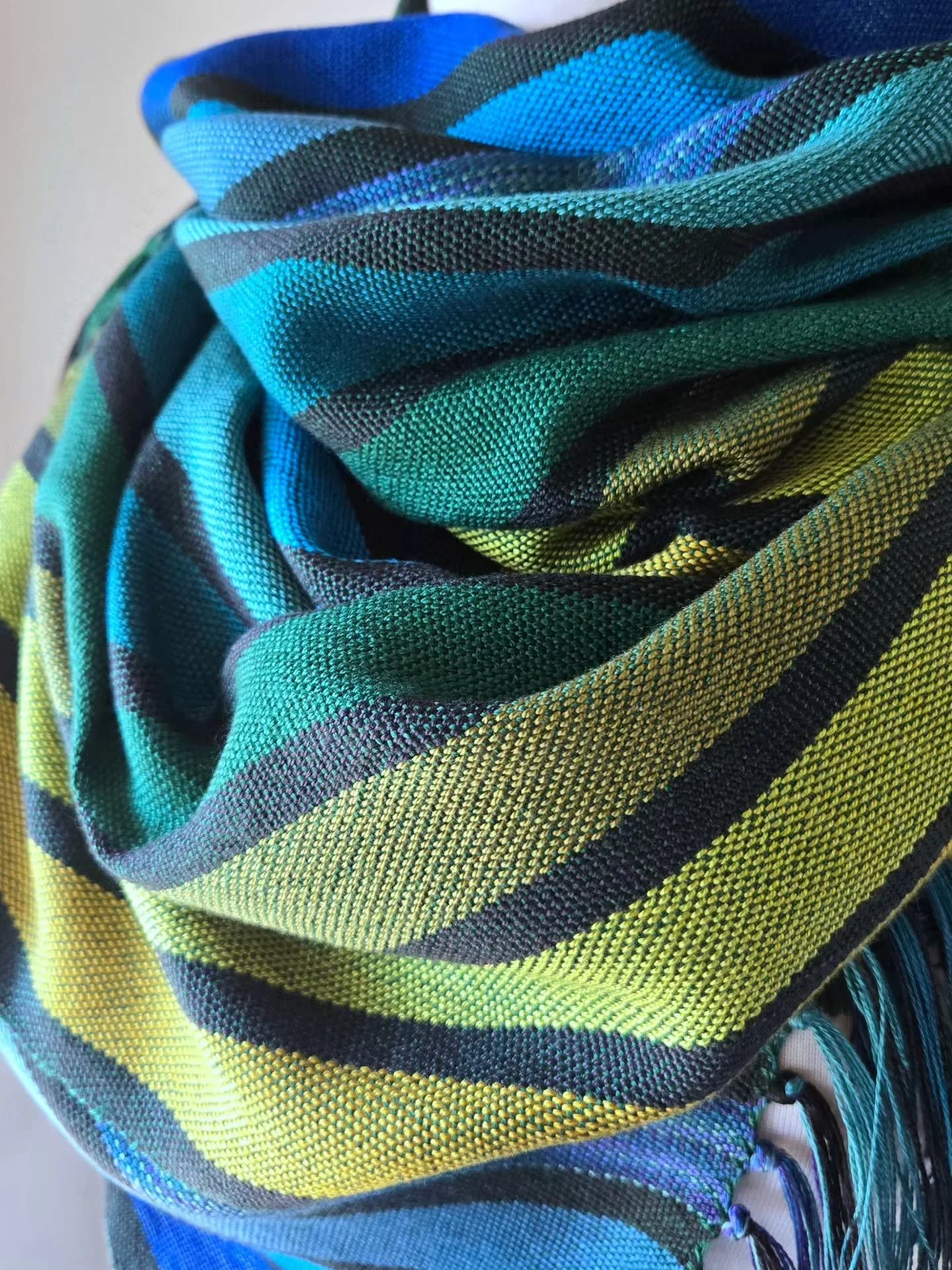 The 3rd scarf from the Peacock Collection 🦚. It's a regular scarf, meaning that is open and has two ends, but my absolute favorite way to wear a scarf is like the first two photos. Where it shows off the fringe, folds, and different directions of th