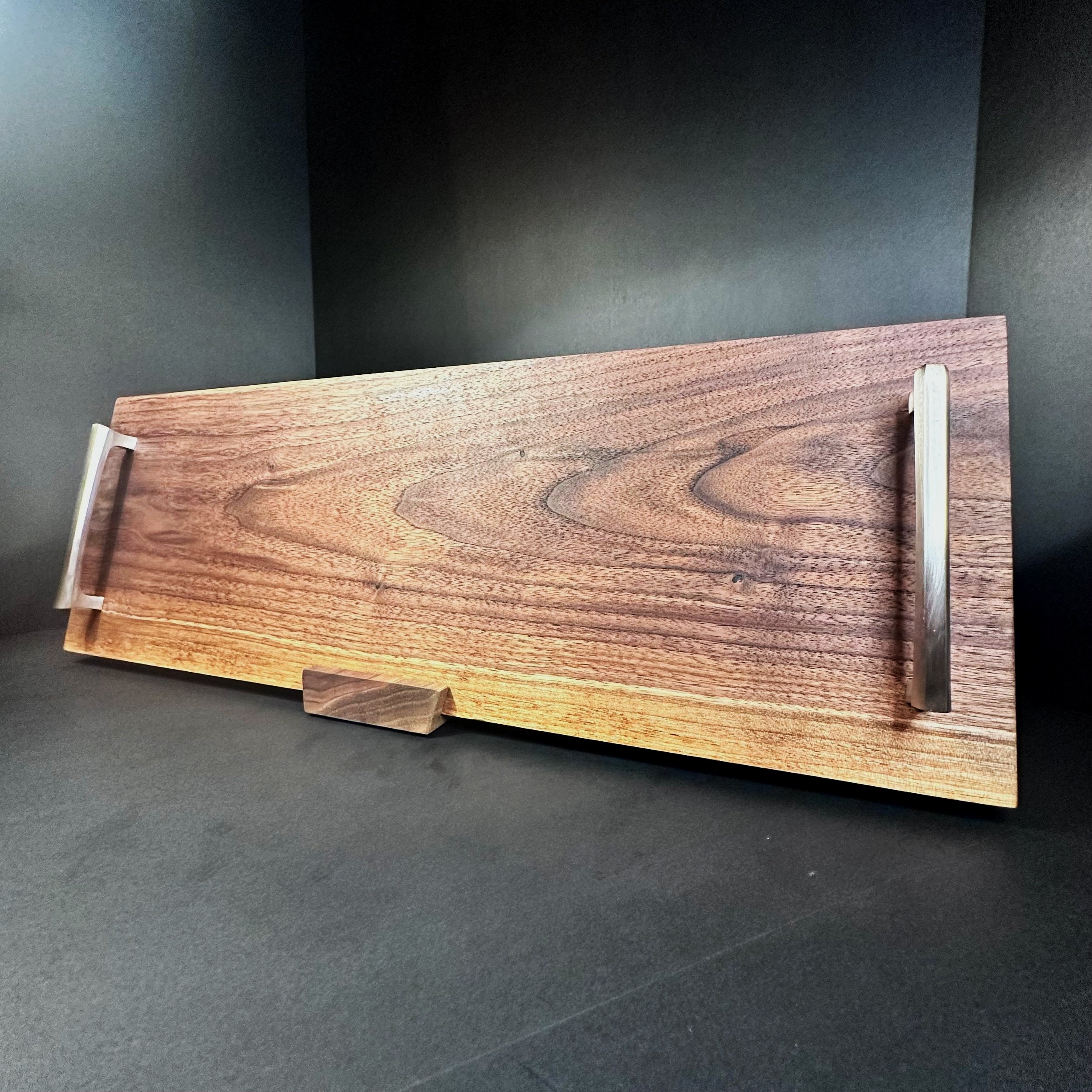 handmade black walnut charcuterie board with stainless steel handles