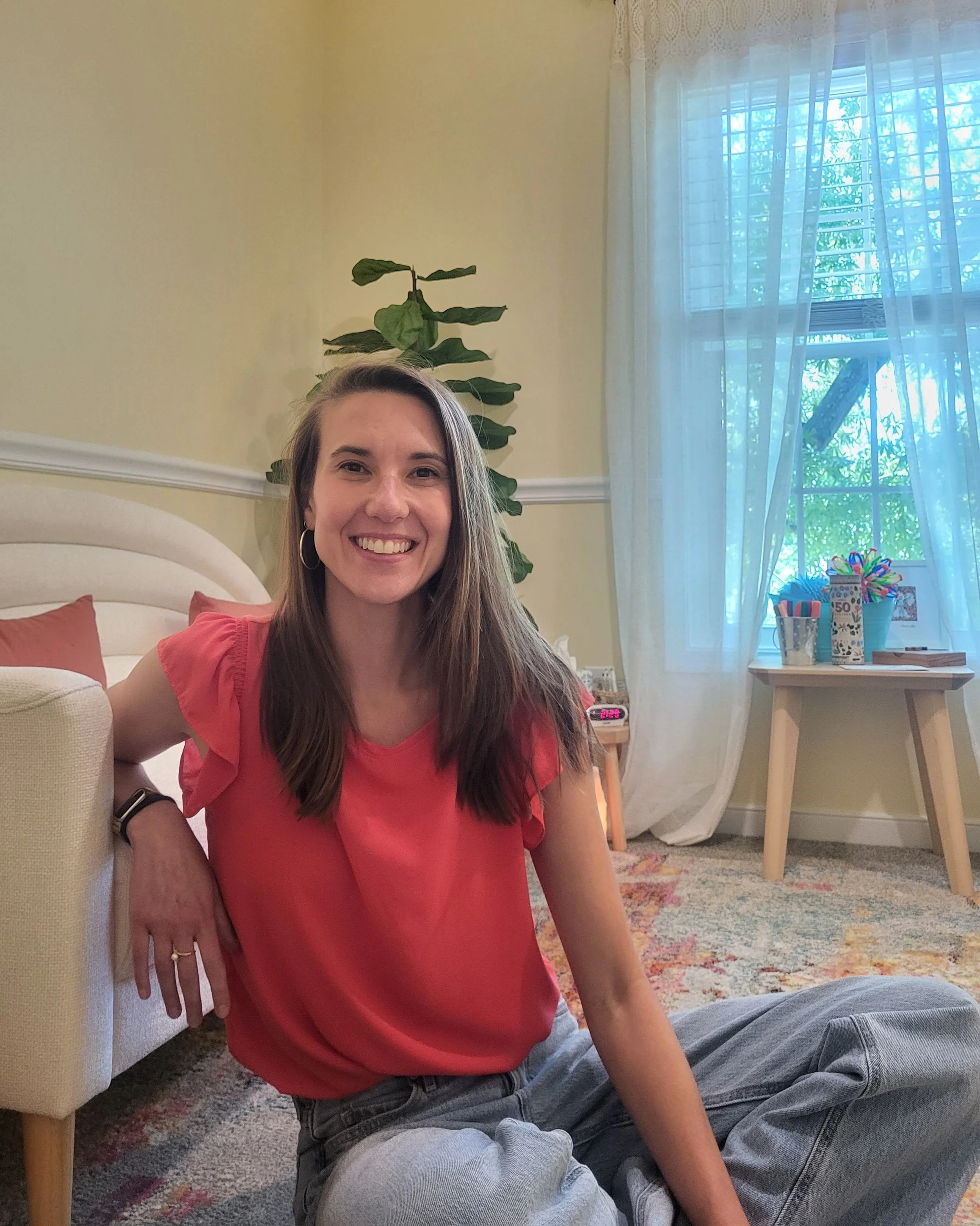 Dee Keller, LPC, child and teen therapist, smiling in her Charlottesville counseling office