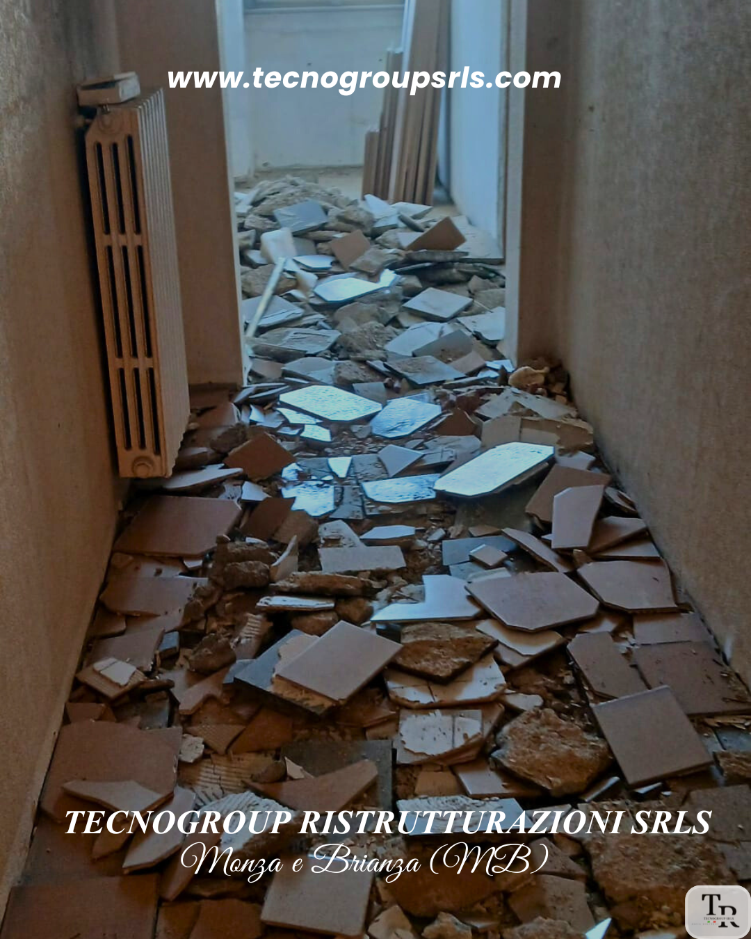 A narrow hallway filled with scattered broken tiles, debris, and rubble from construction or renovation work, with an open door at the end leading to another room.