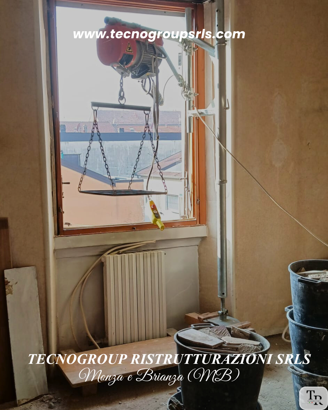 Interior of a room under renovation with construction tools, buckets with building materials, and a window with scaffolding outside.