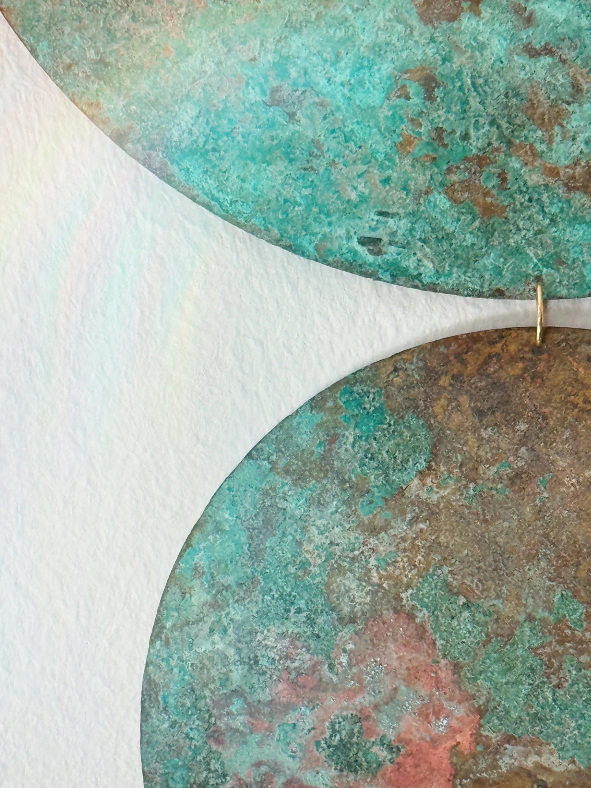 Close-up of the teal and rose patina texture on SAMAY brass wall hanging