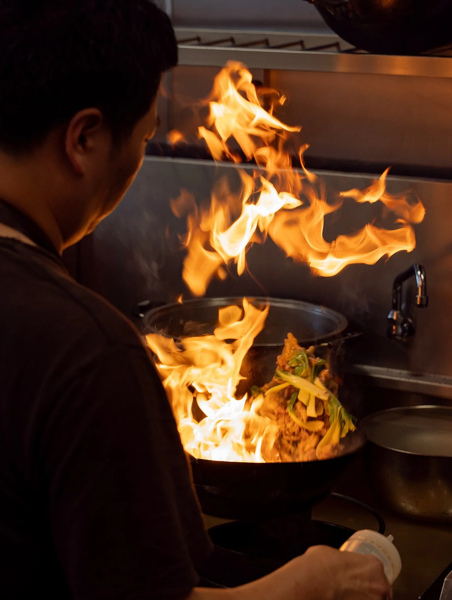 The dance of fire and flavour! 🥢🔥 Behind the pass with our wok masters at work! 

#wok #fire #chef #cooking