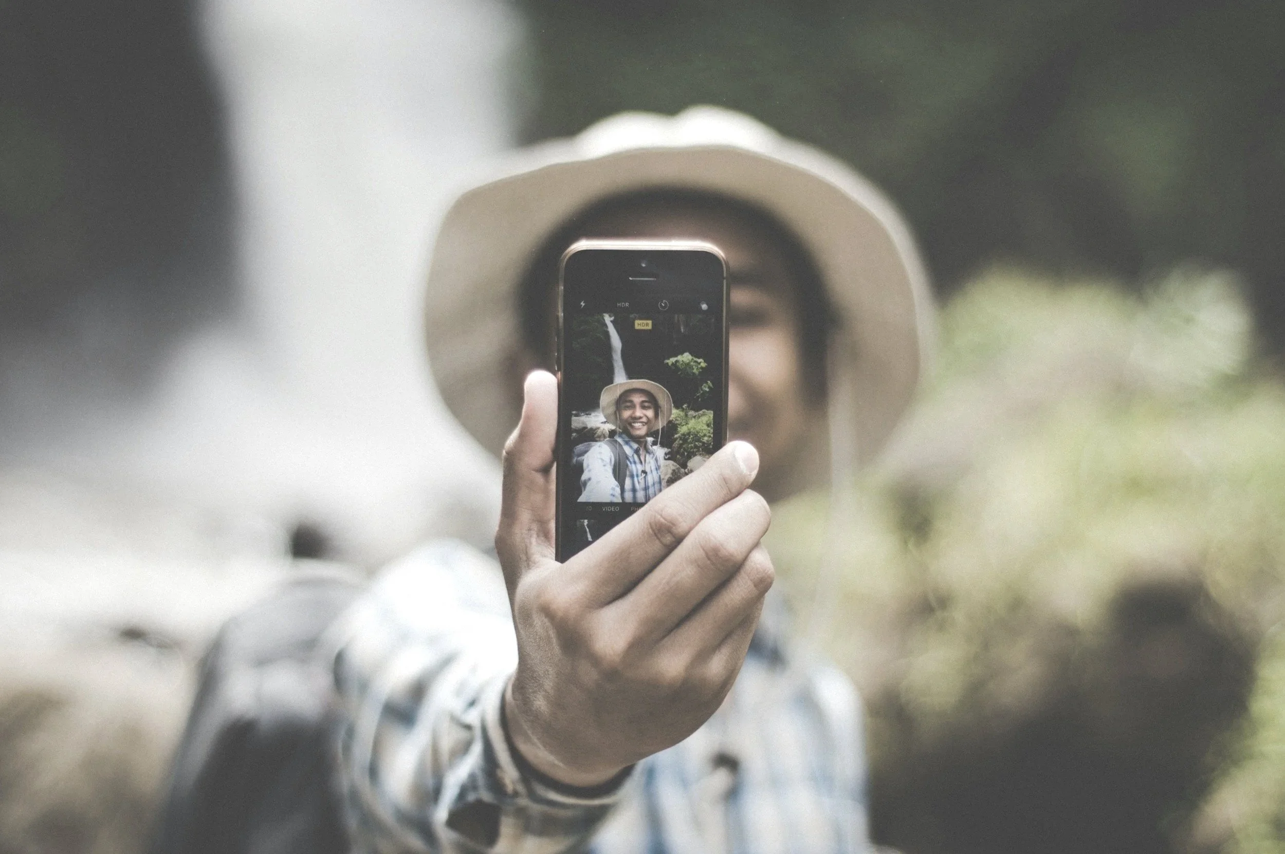 Person holding a camera, representing confidence, self-expression, and clarity.