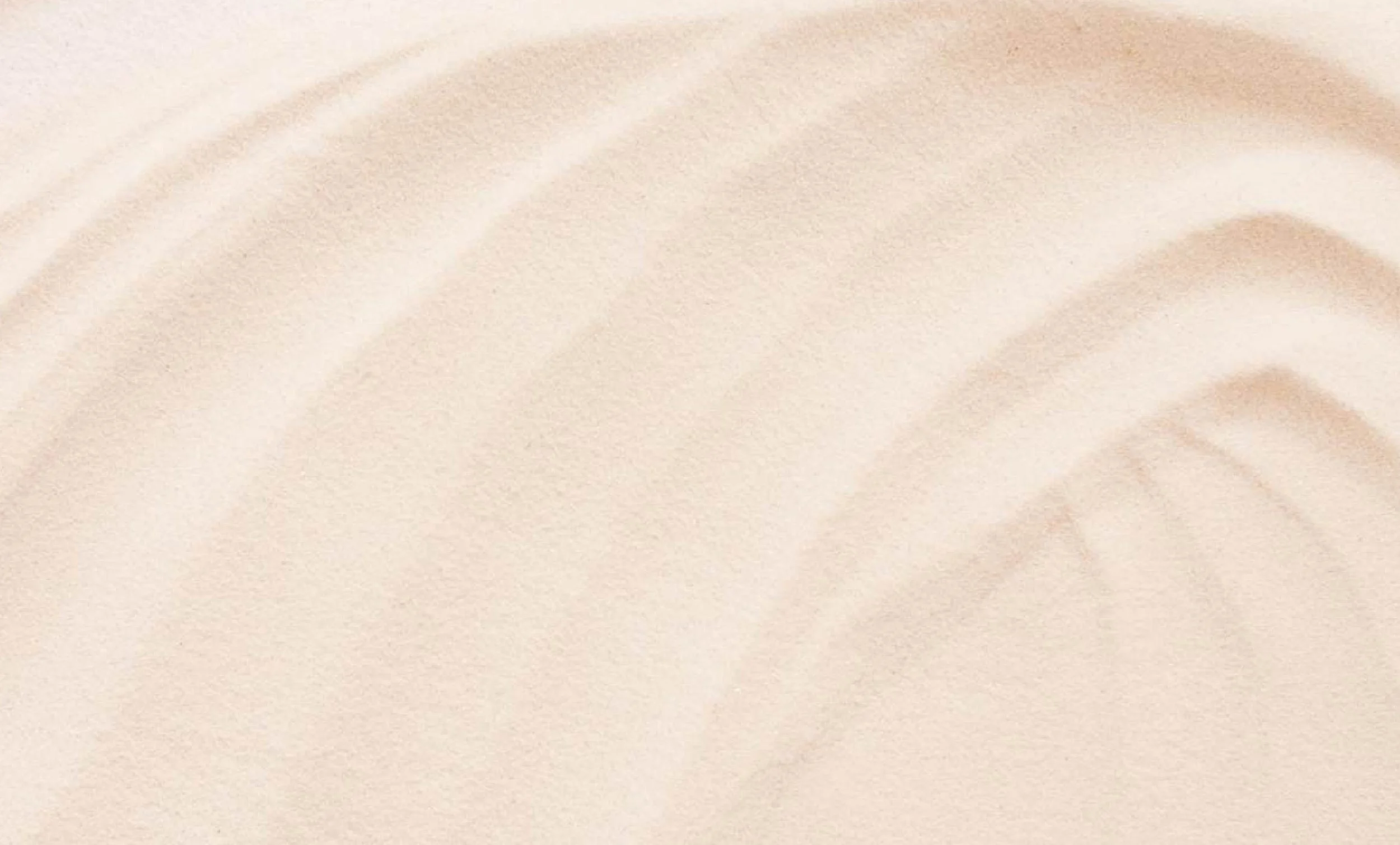 Close-up of soft, beige fabric with subtle texture and gentle folds.