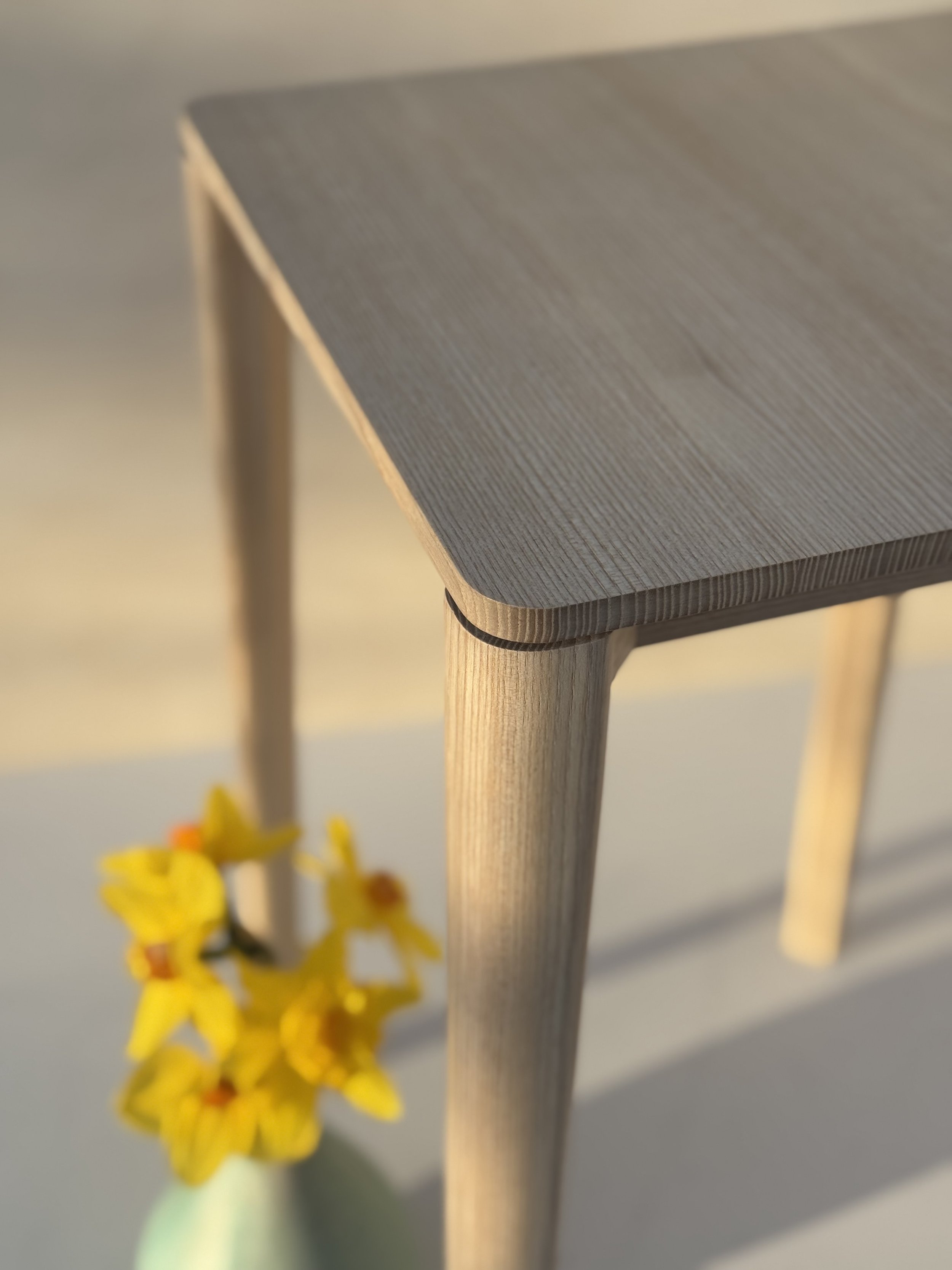 June Table by Mitch Polley Design, close up of top and leg detail. A minimalist side table with clean lines, handmade from English Ash.