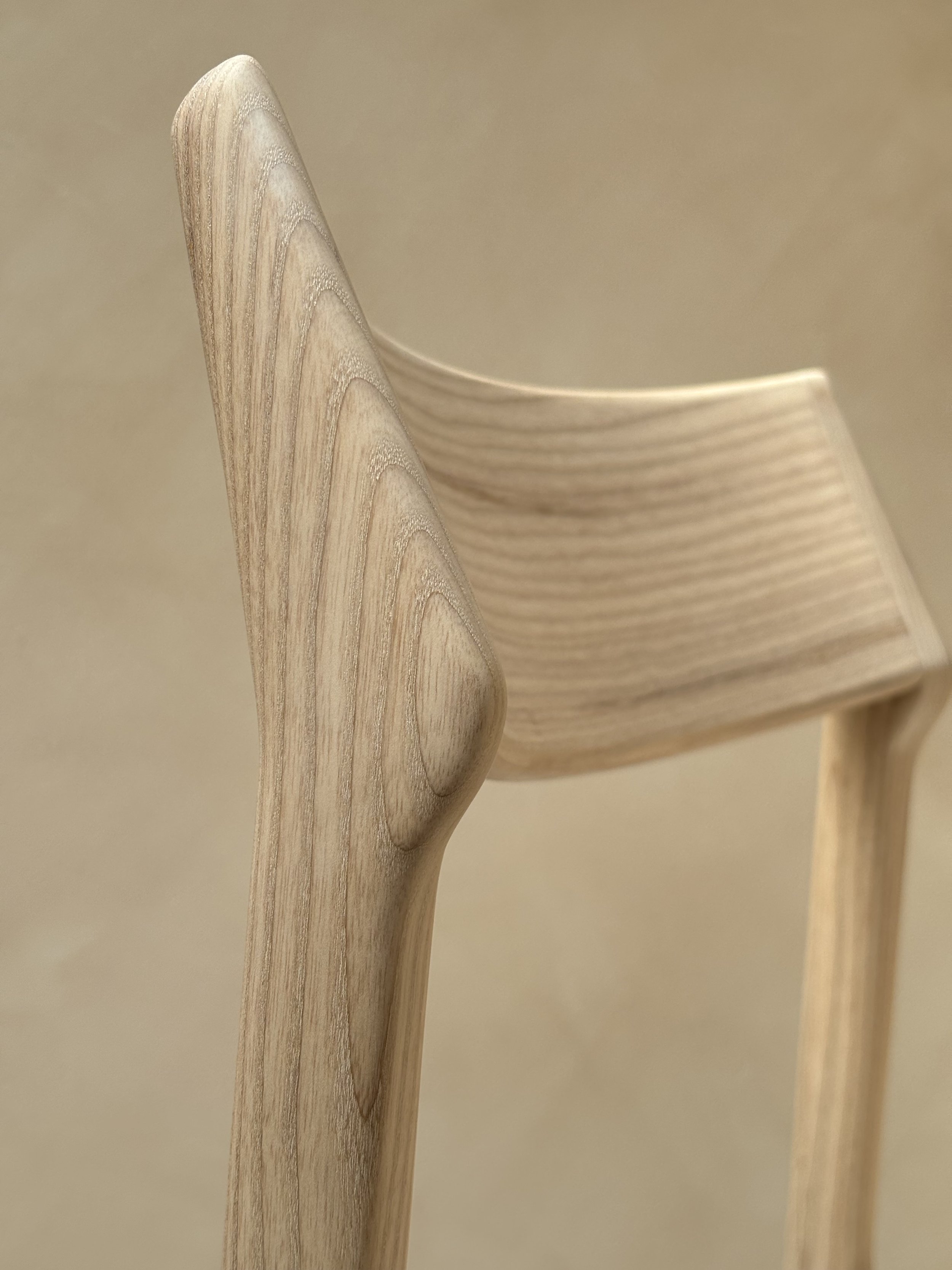 Eleven Chair by Mitch Polley Design, close up of backrest. A contemporary dining chair with a curved backrest and scooped seat, handmade in English ash.