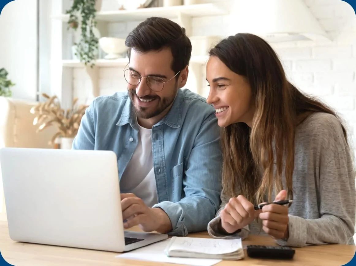 Two people reviewing a web design project on a laptop