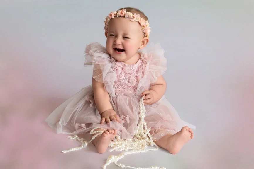 Sitter baby milestone photography session featuring a baby girl sitting independently in a Central NJ studio.